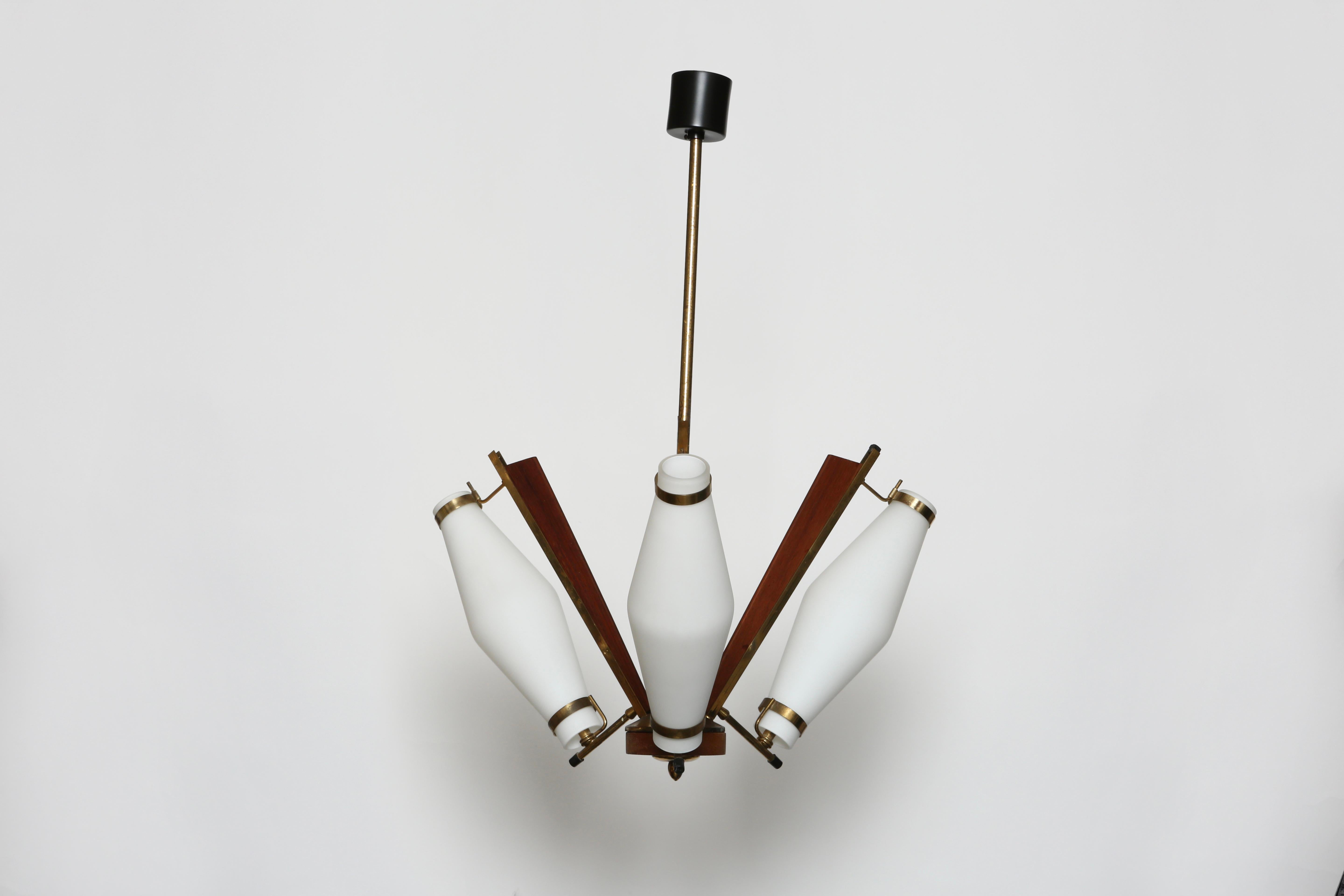 Stilnovo style ceiling pendant.
White matte opaline glass, wood and brass frame.
Made in Italy in 1960s.
Complimentary US rewiring with a custom ceiling plate upon request.
Takes 3 candelabra sockets.
Overall drop ( height) is adjustable, can