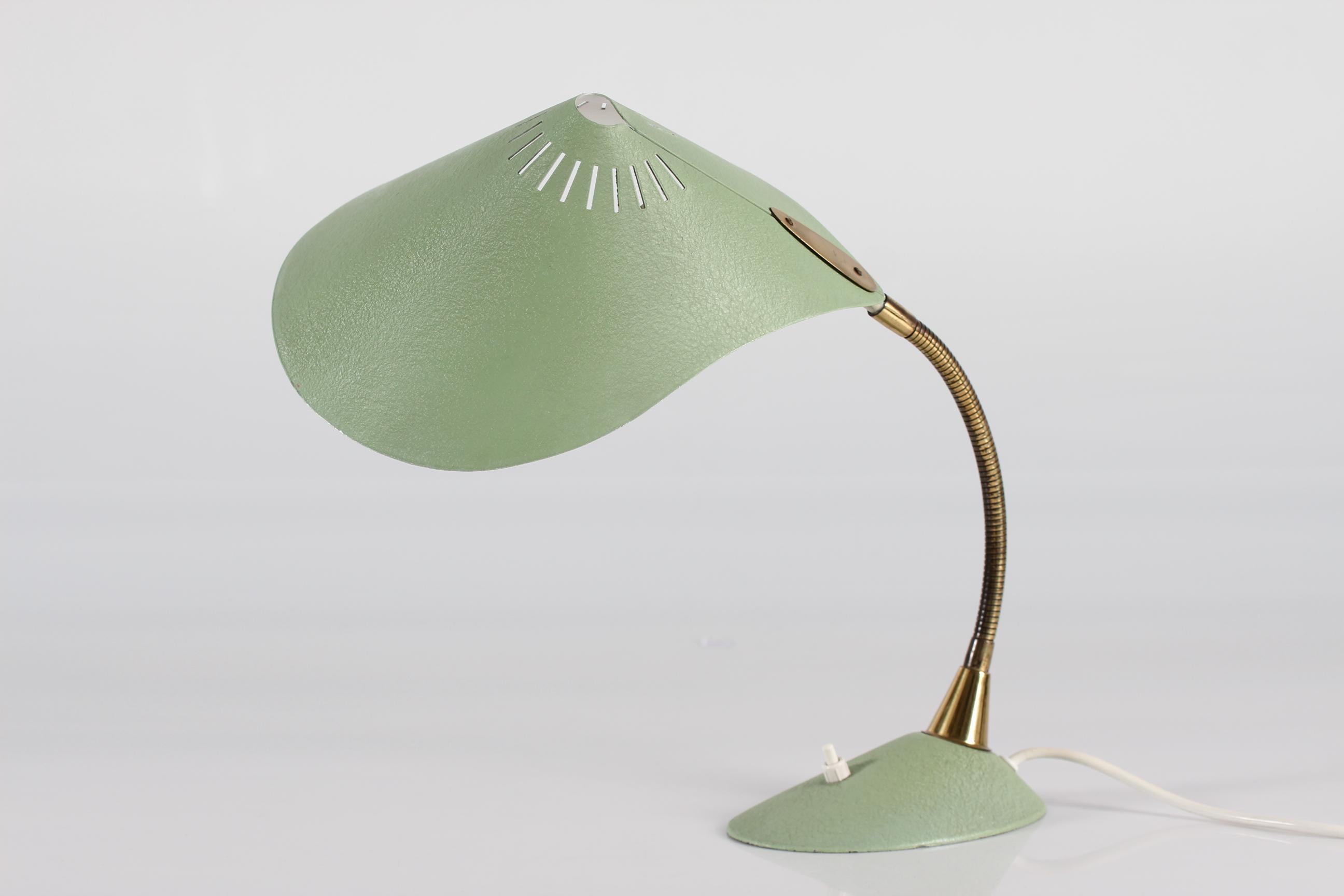 Stilnovo style Cobra desk lamp made of metal with pastel green lacquer and openwork lace shade and brass arm.
It has a gooseneck arm which is adjustable in all kind of directions.

Manufactured by the German company Cosack Leuchten in the