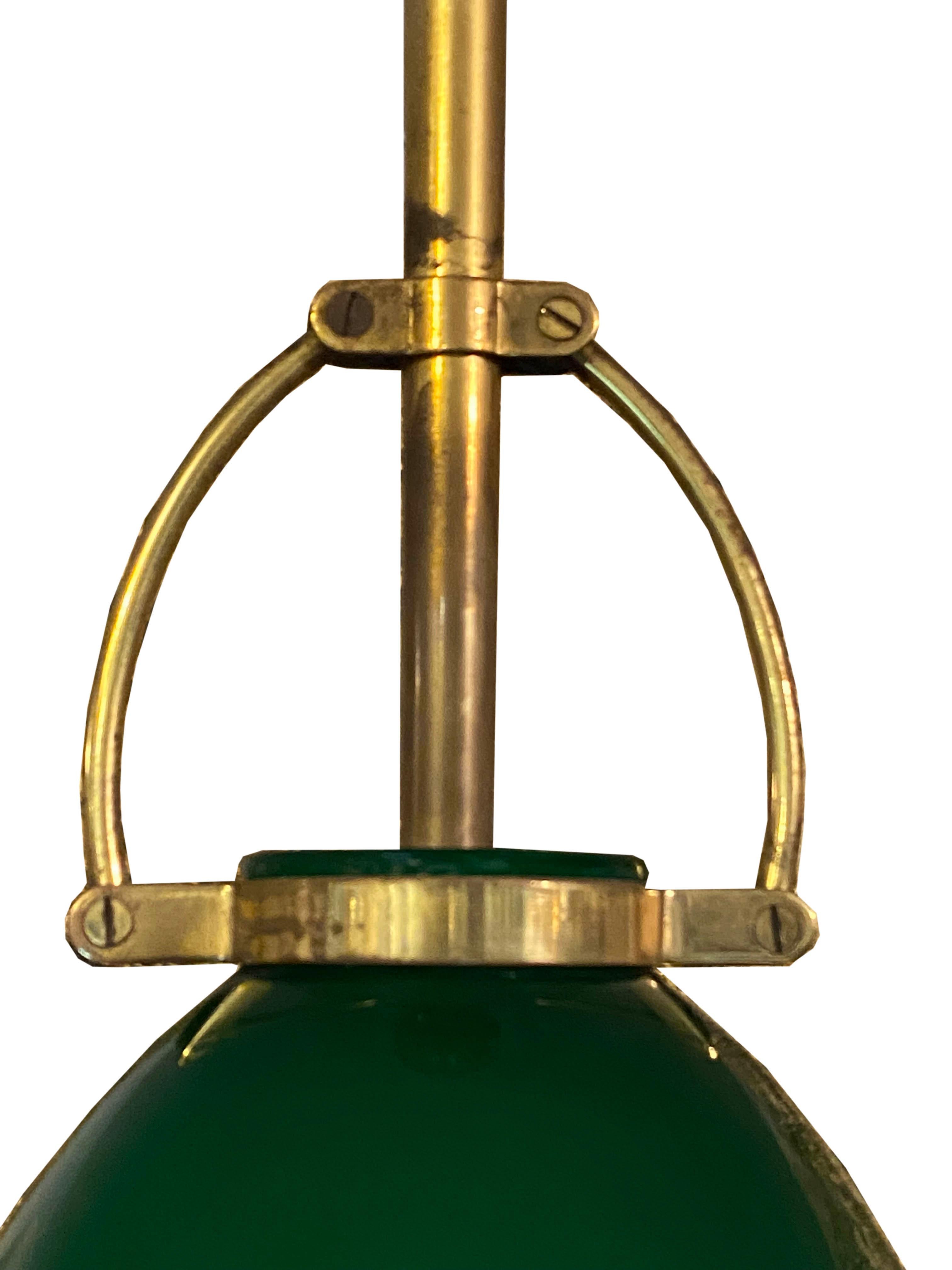 Ceiling lamp with a green glass diffuser with an opaline interior.

The lamp is made in Italy and dates from the 1950s. It has a brass stem and a circular base.

In the style of Stilnovo.