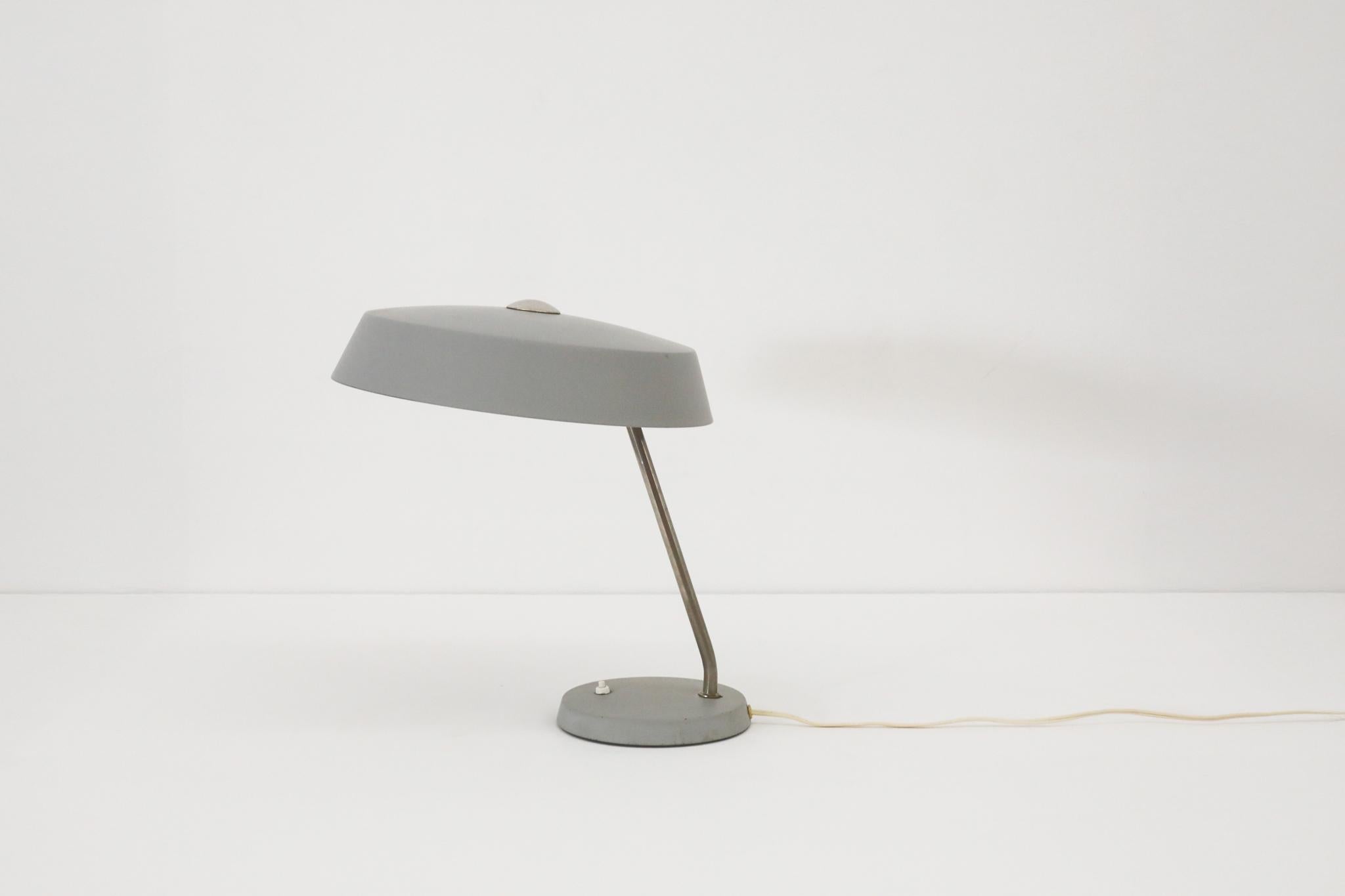 Gray enameled Stilnovo style industrial desk lamps by V.E.B NARVA Leuchten. Chrome stem with gray enameled base and shade. In original condition with wear consistent with age and use. Medium base (E26/27) bulbs. Two available in similar condition