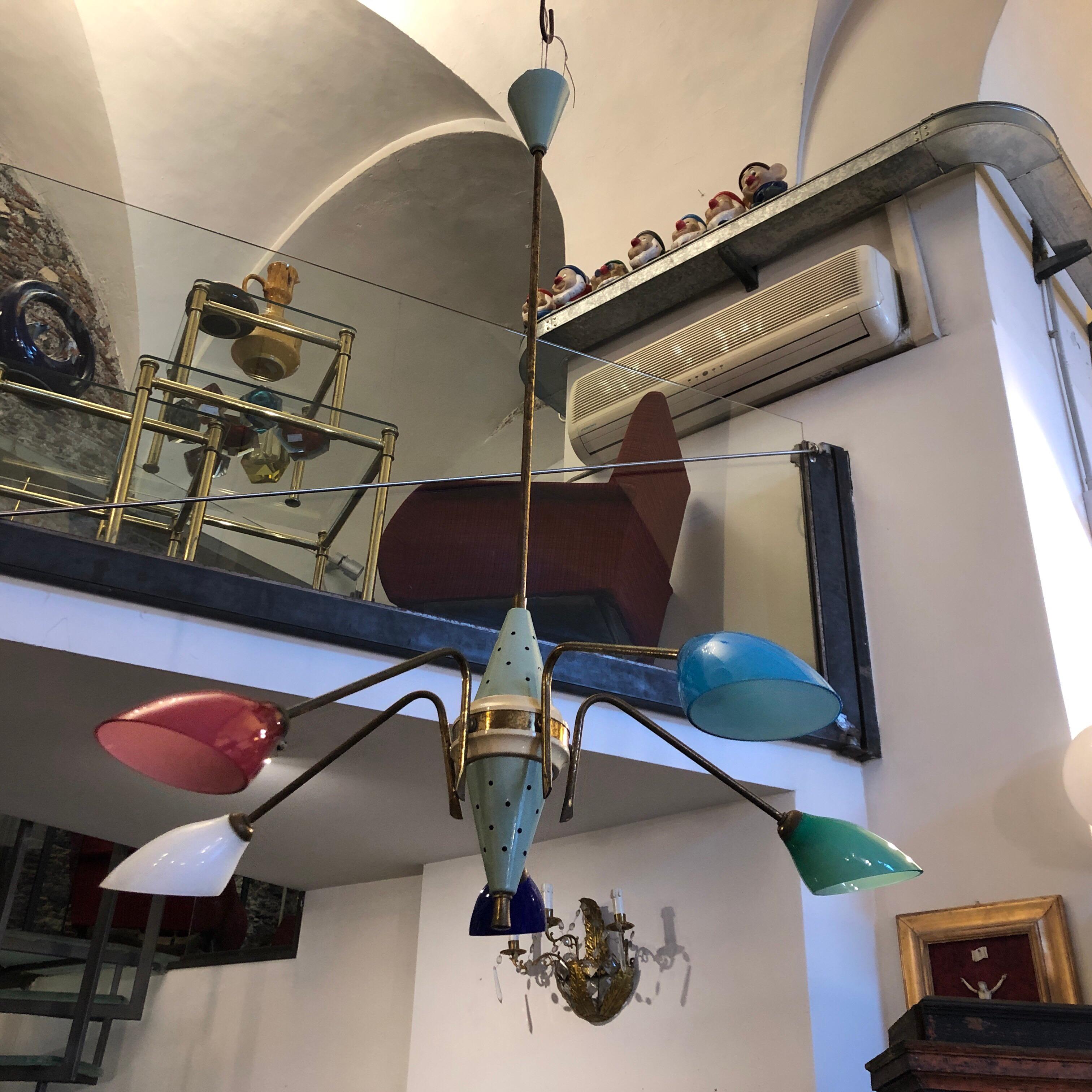 A Mid-Century Modern chandelier with five original glass in different colors. It's made in Italy in the Fifties. brass is in original patina, it works 110-240 volts and need five regular e14 bulbs