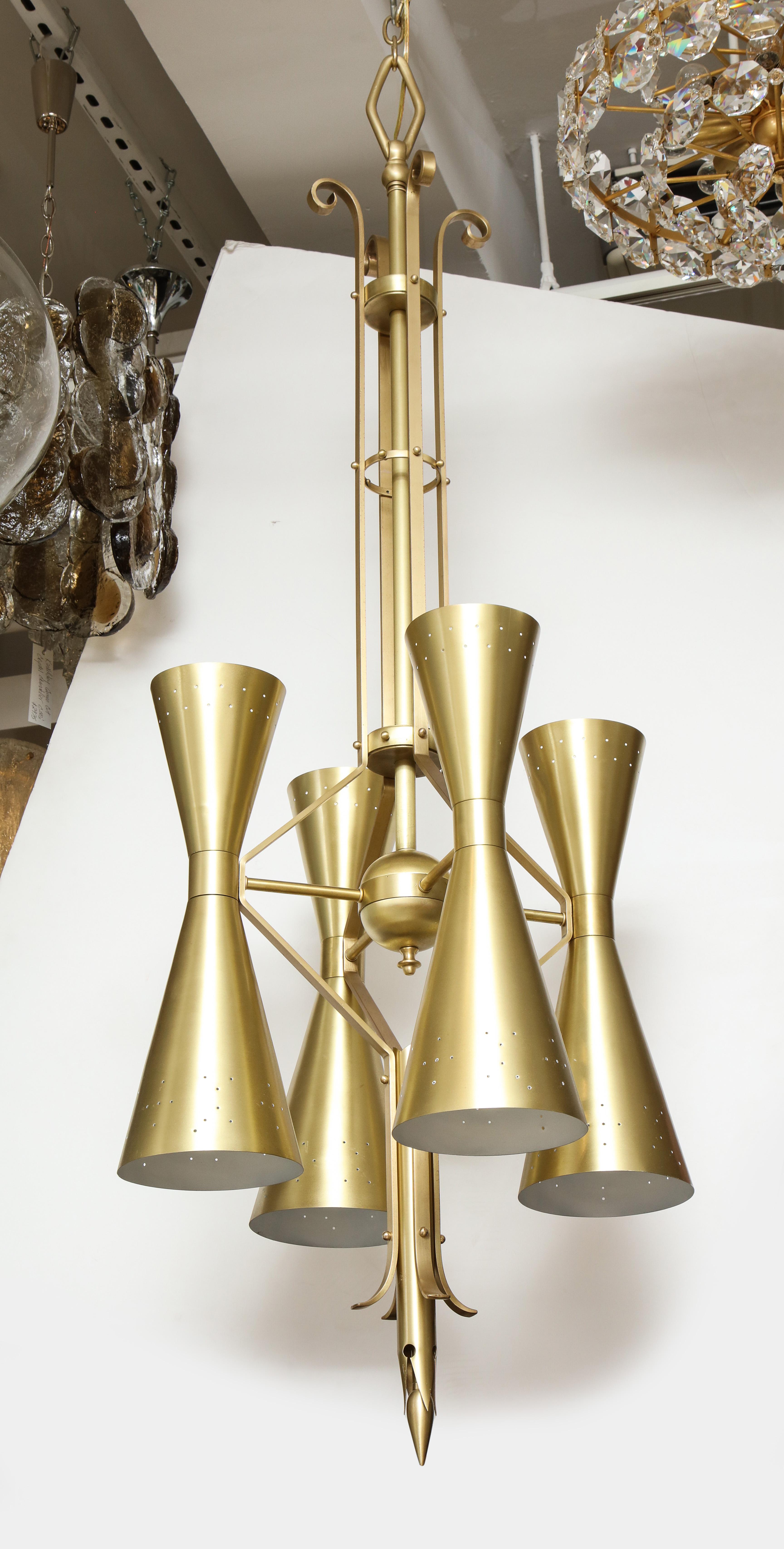 Italian modernist satin brass chandelier with 8-light sources. Chandelier is constructed of solid brass elements and has an architectural flair. Comes with approximately 3ft of chain and canopy. Rewired for use in USA.

Currently 2 are available