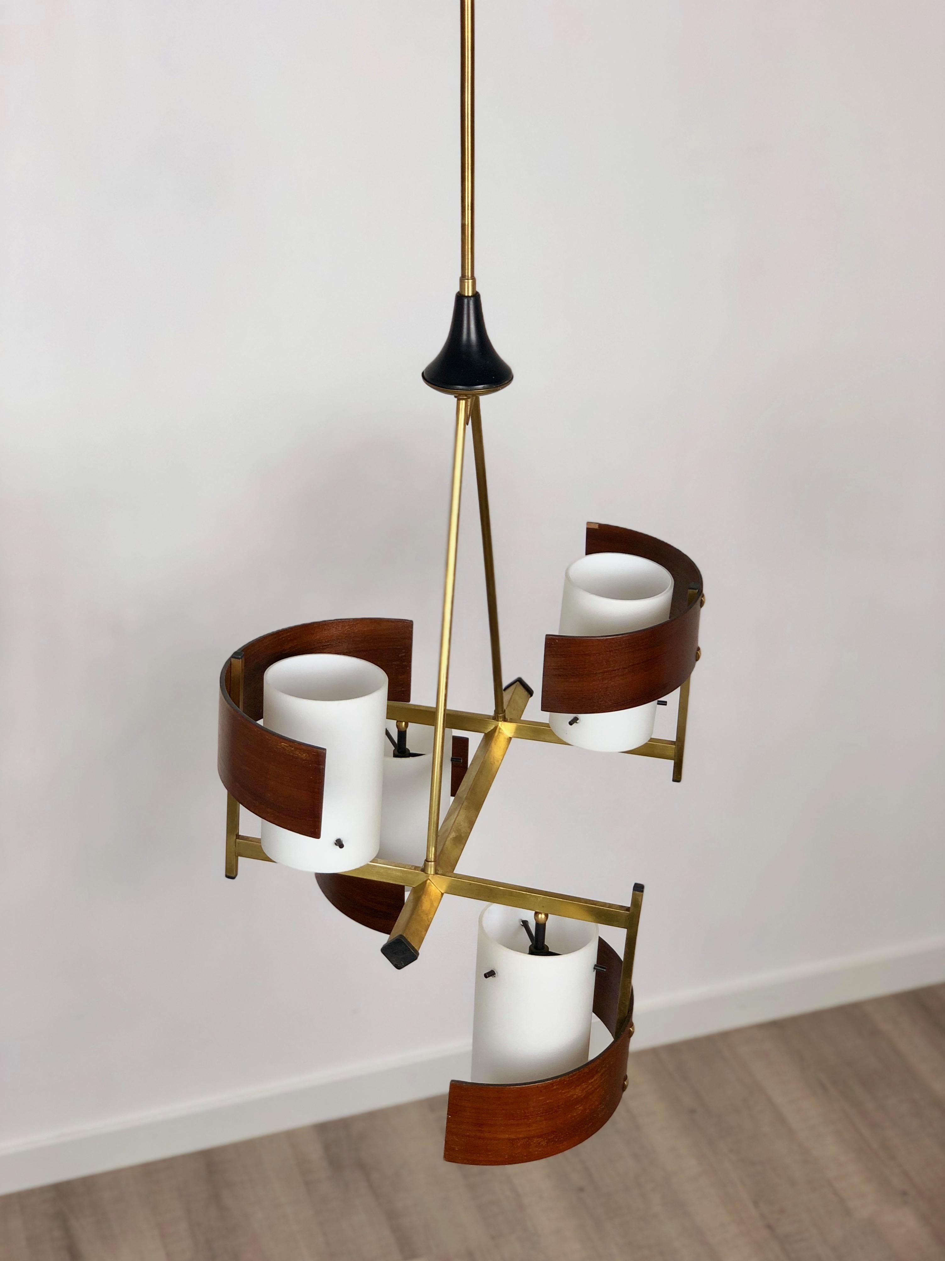 Italian modernist chandelier with 4 white opaline glass shades embellished with brass and teak frame and details. Typical modernist piece of the 1960s.
