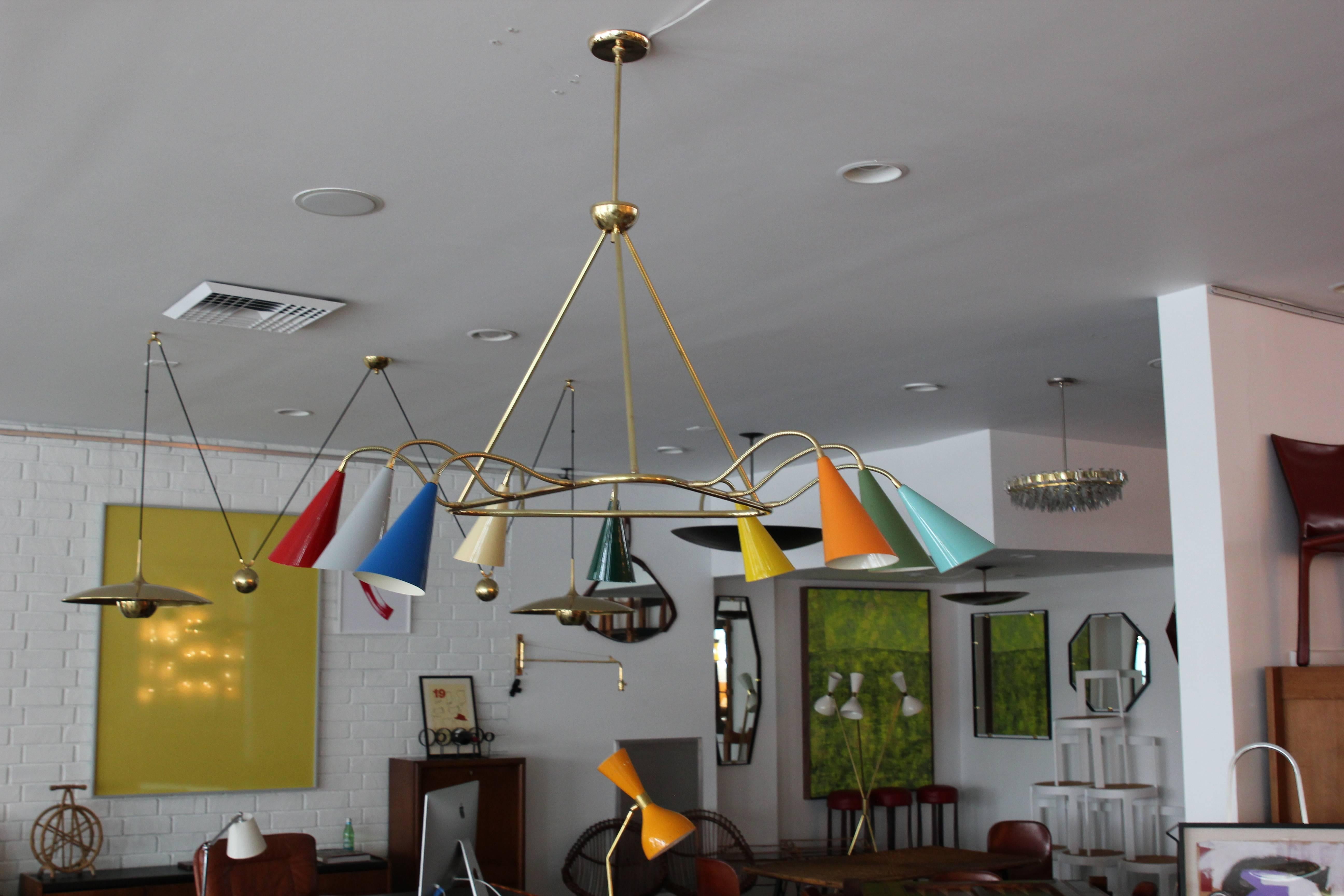 Stilnovo style pendant with nine multicolored cones on adjustable brass arms.
 