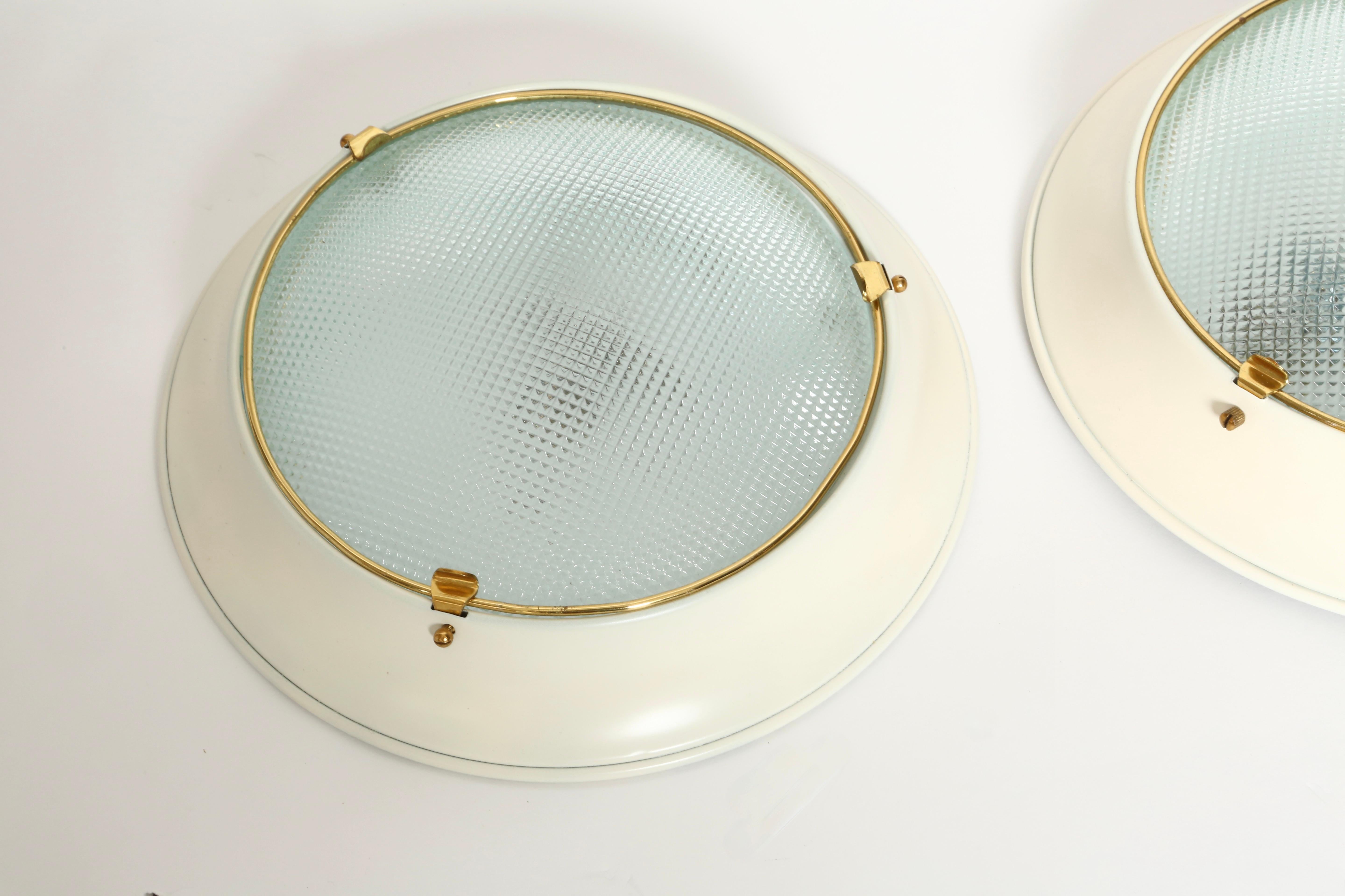 Stilnovo style flush mount wall or ceiling lights.
Glass, brass, enameled metal.
One medium base socket each.
Rewired for US.
Price is for one light.
8 lights are available.

We take pride in bringing vintage fixtures to their full glory again.
At