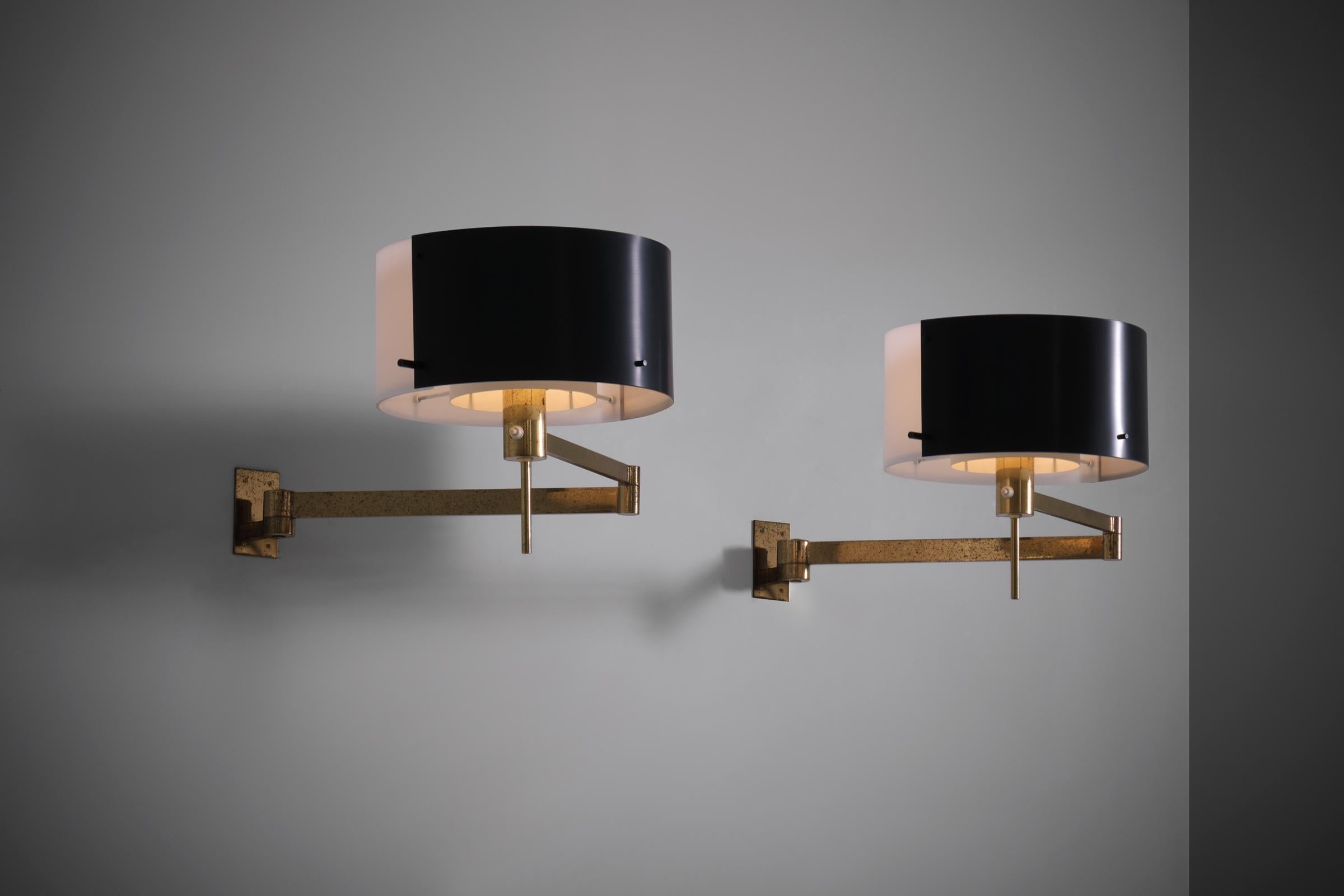 Stilnovo swing arm Wall Lamps, Italy 1960s. Exceptional and refined design in shape and use of materials; brass, lacquered aluminium and white acrylic. The lamp can be put in different positions due to the two swing joints hinges. Each lamp has one