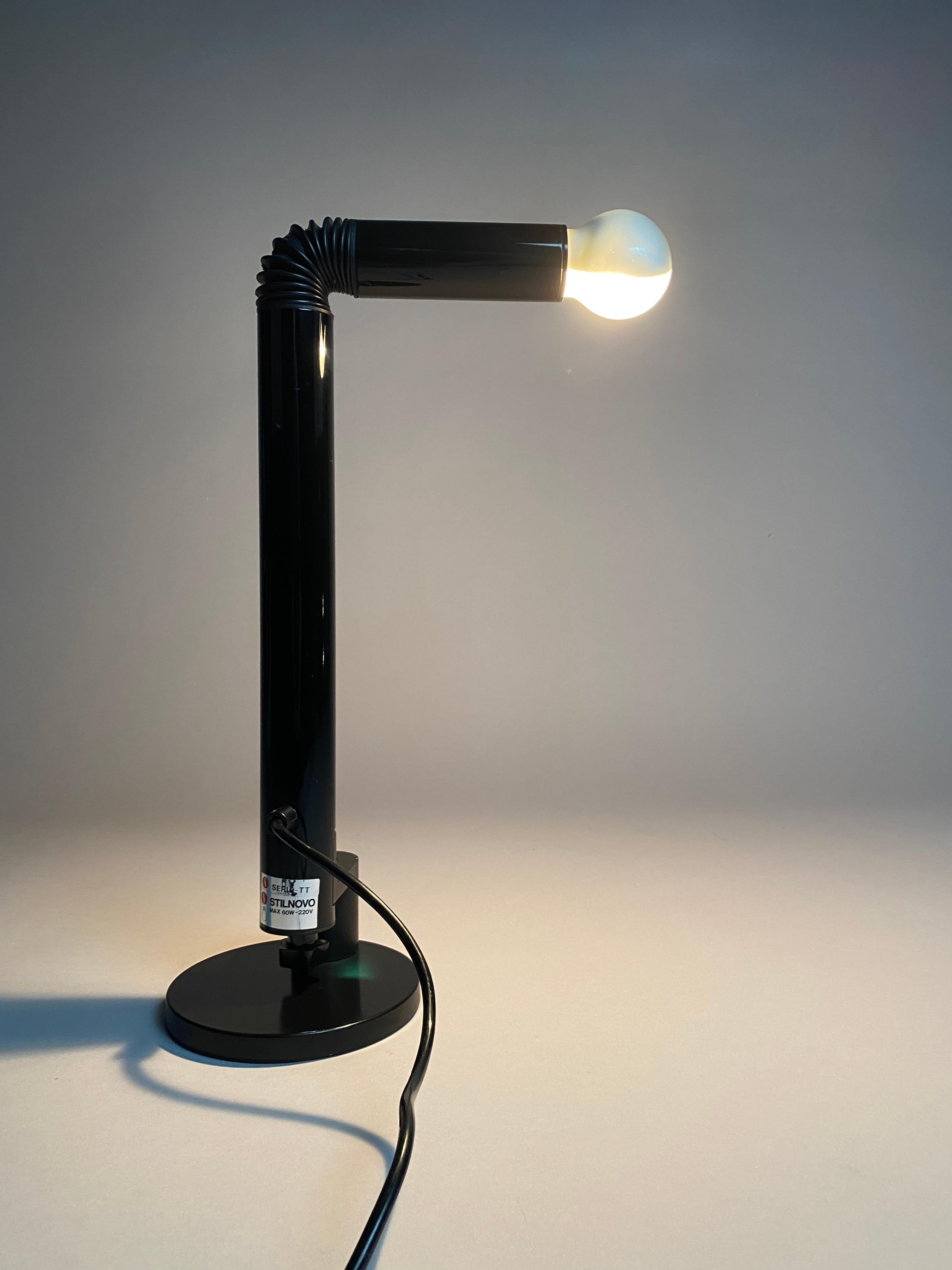 Illuminate your space with timeless elegance and unparalleled style with the iconic Black Vintage Periscopio Table Lamp, designed by the visionary duo Danilo and Corrado Aroldi for Stilnovo, Italy in 1967. A true embodiment of mid-century modern
