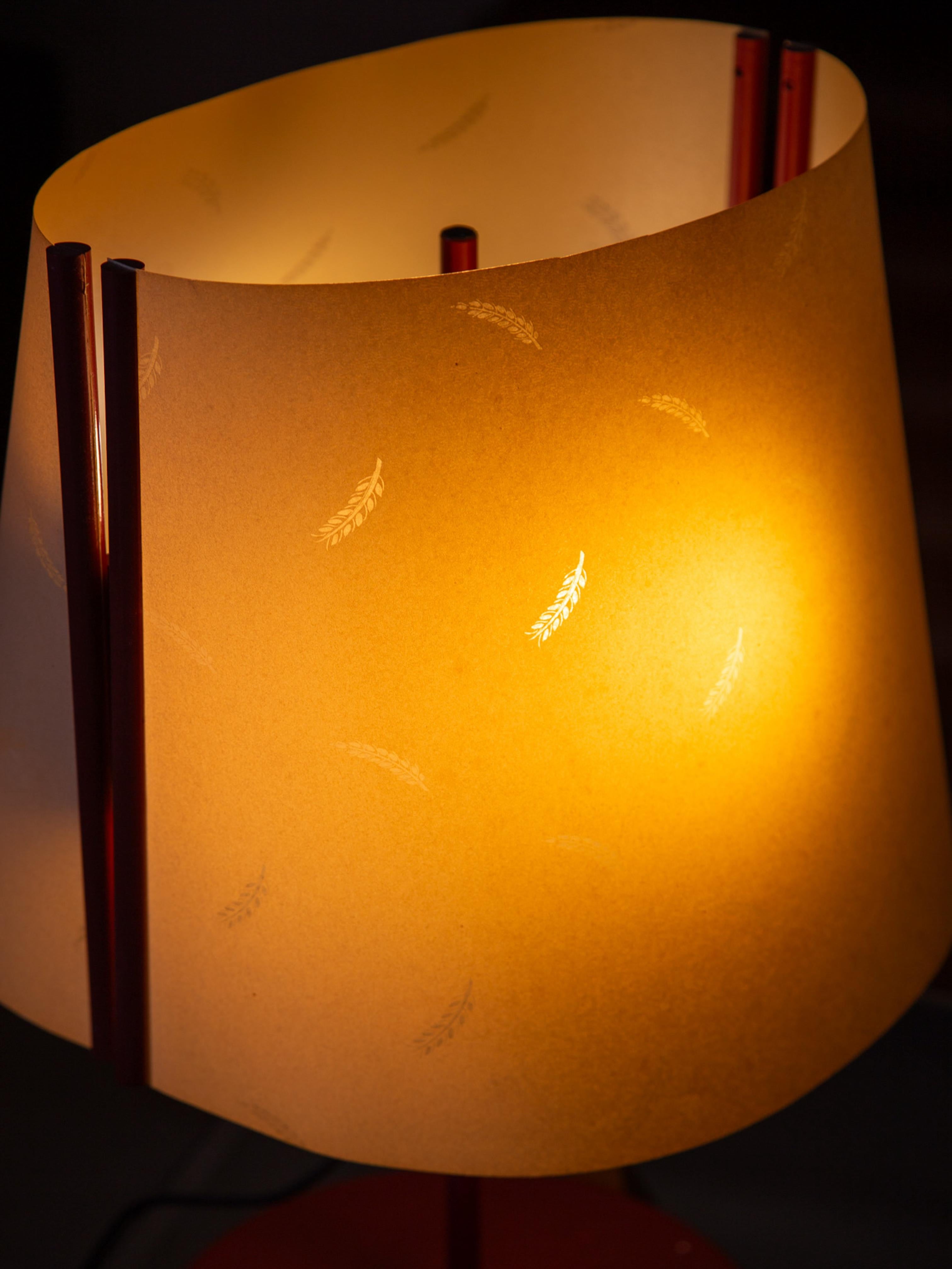 Marked Stilnovo 
This striking 1980s Italian table lamp is attributed to Stilnovo, one of Italy’s most iconic lighting manufacturers. A collectible example of postmodern Italian design, the lamp features a minimalist red-painted metal base and