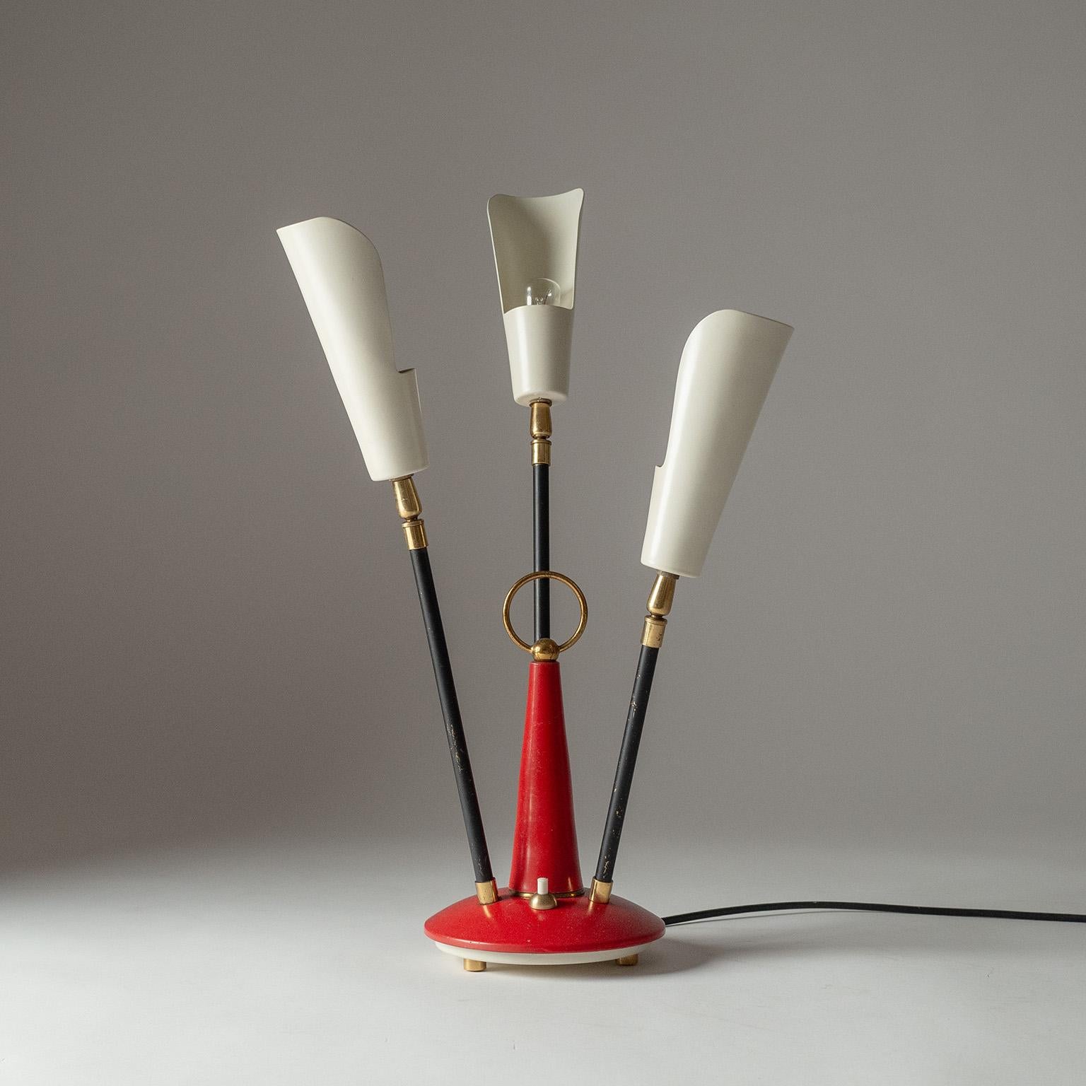 Rare three-arm Stilnovo table light from the 1950-1960s. Red lacquered base with three black stems culminating in off-white shades. Nice original condition with some patina on base and stems. There original brass and ceramic E14 sockets with new