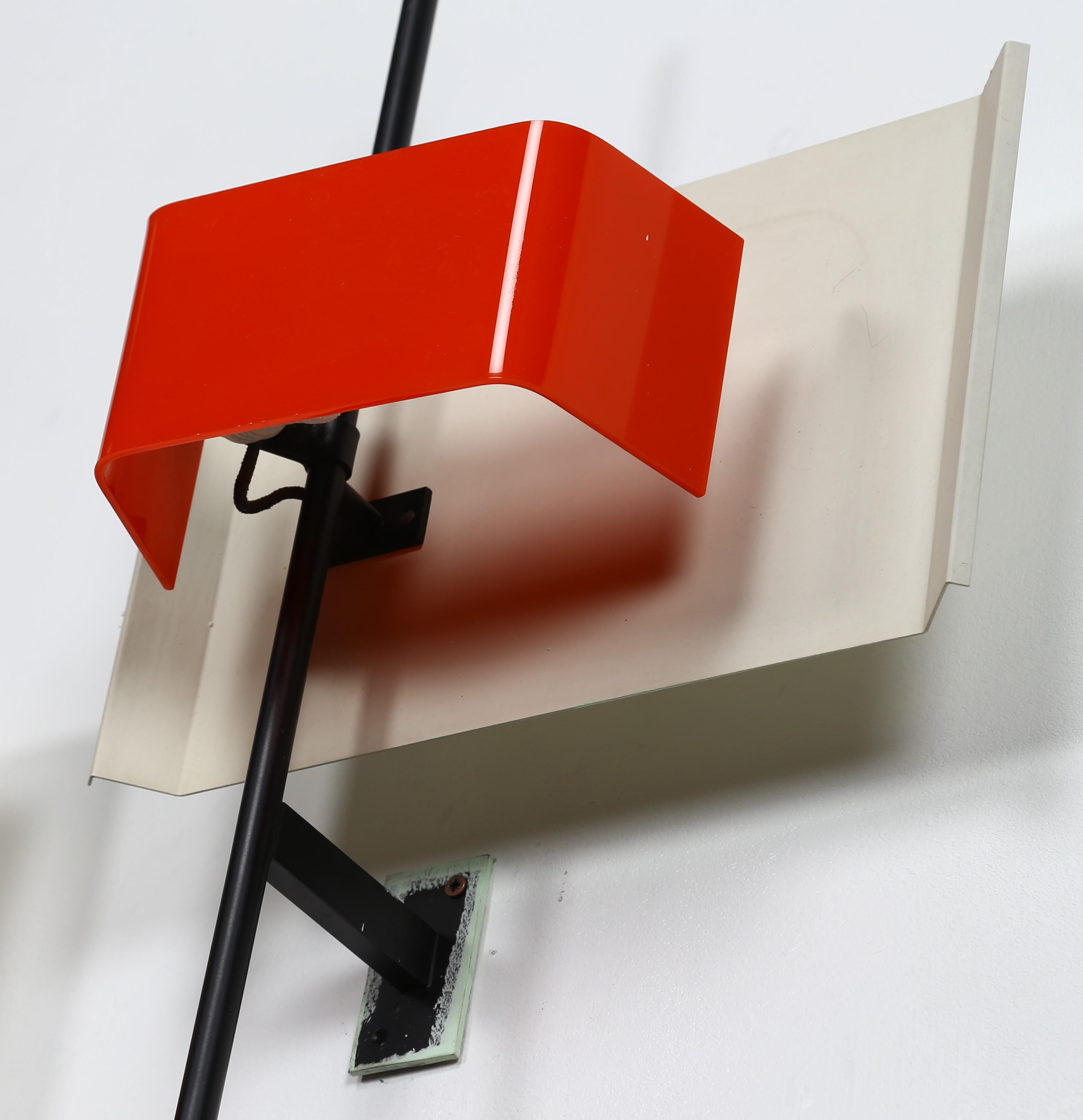 Spectacular large sized sculptural wall lamp model 2020 designed by Bruno Gatta and manufactured by Stilnovo, Italy 1955.
Minimalist wall lamp with black lacquered arm, white lacquered shade, a red plexiglass diffuser and brass details.
The lamp