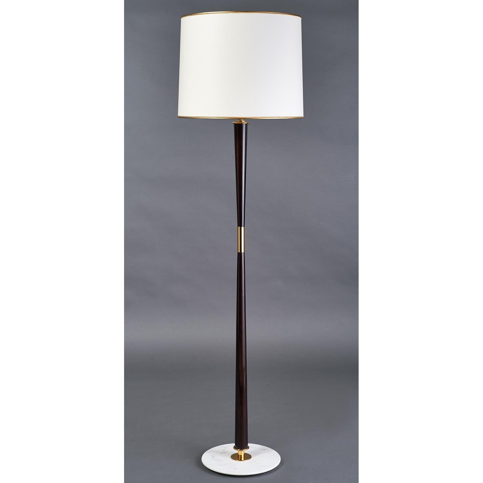 Stilnovo, attributed to
Elegant polished mahogany stained wood floor lamp with polished brass mounts, marble base.
Italy, 1950s
Dimensions: 68 H x 18.5 Diameter
Rewired for use in the US with 3 standard base bulbs.
       