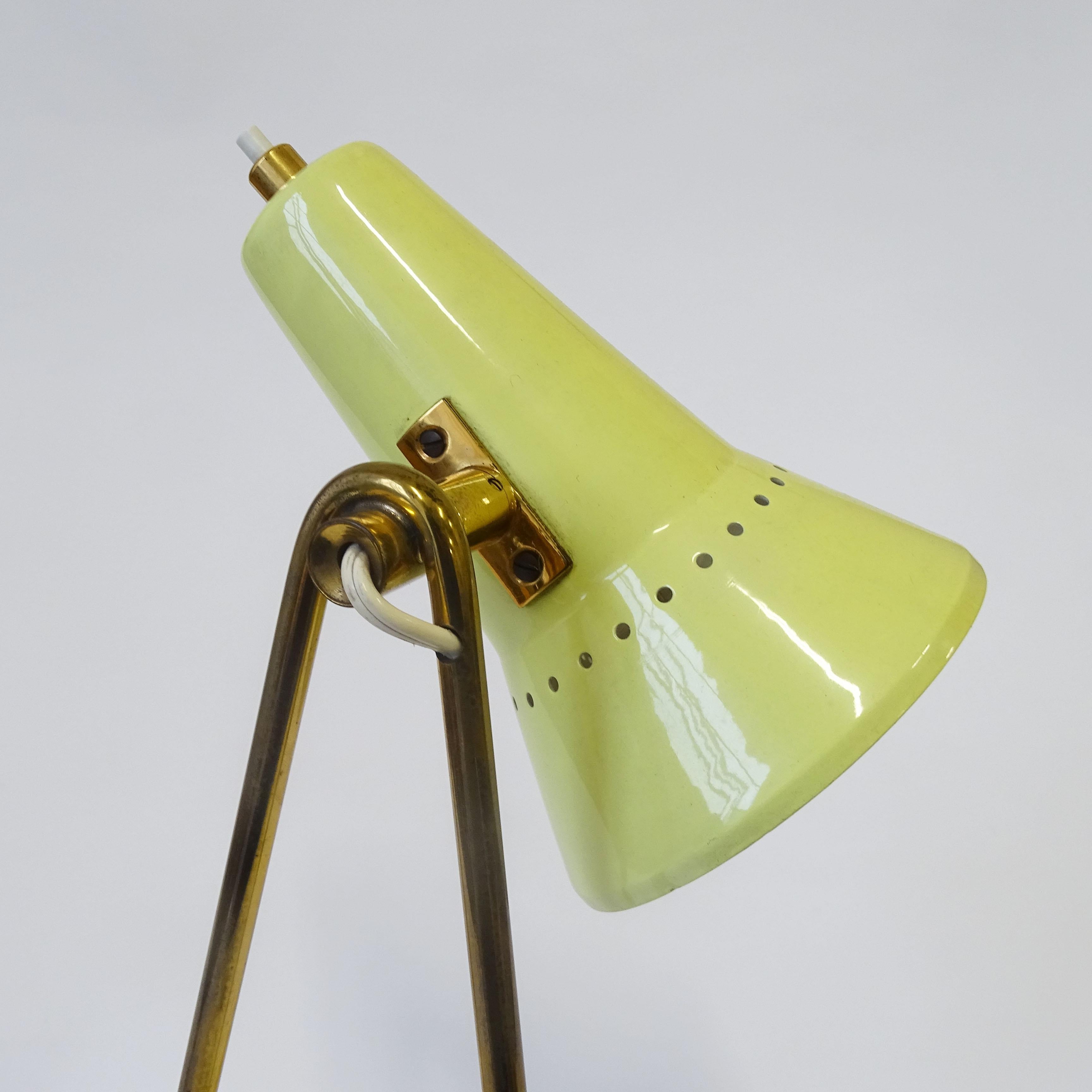Splendid Stilnovo yellow and brass lamp, which can be used either as a wall lamp or a table lamp.
Original Stilnovo label