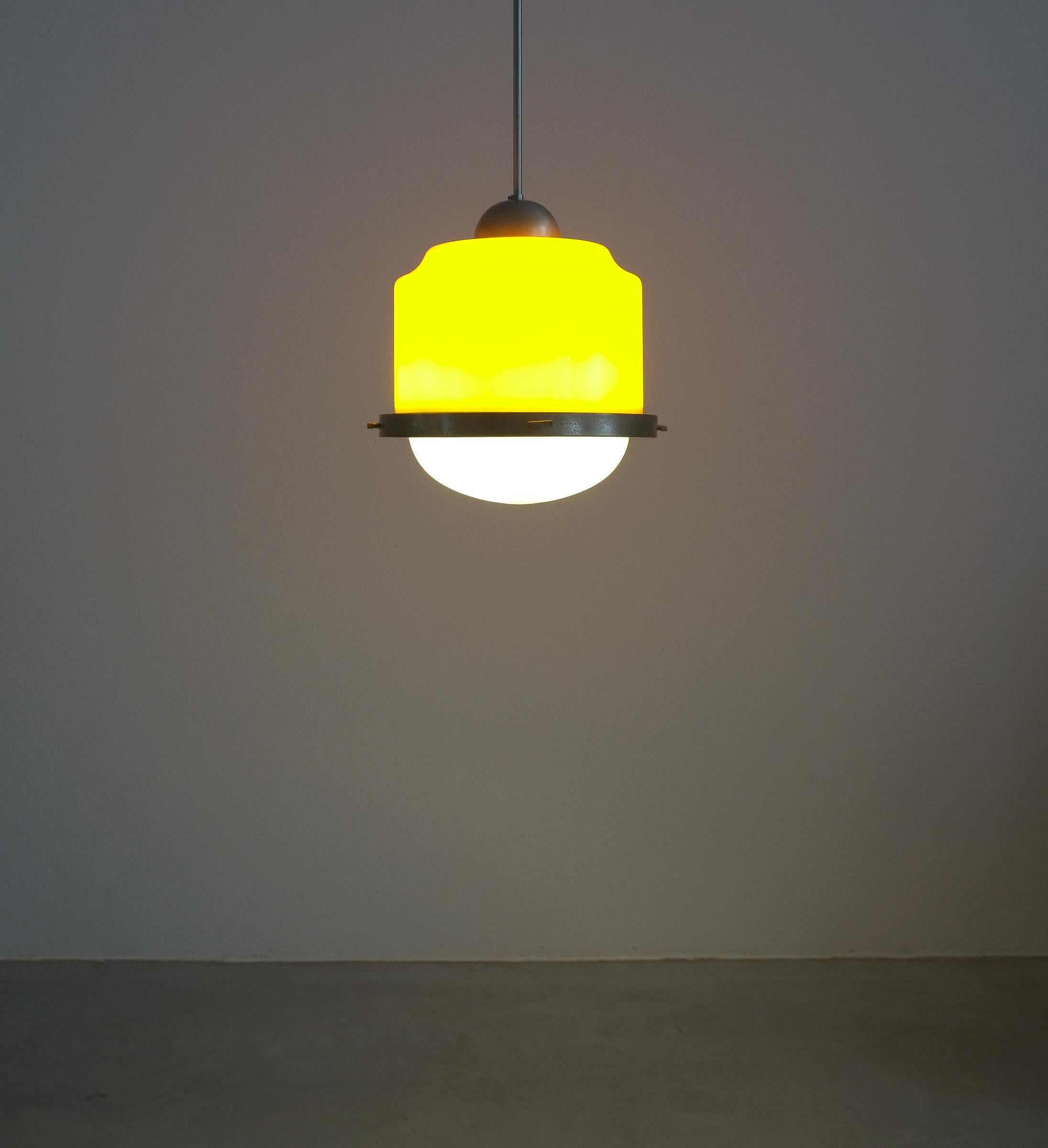 Stilnovo yellow glass pendant lamp glass, circa 1950

Beautiful Italian pendant light with a yellow glass shade and a white opal glass down light shade. Aluminum and steel hardware. It takes 3 e14 light bulbs, LED's are working also. It's in good