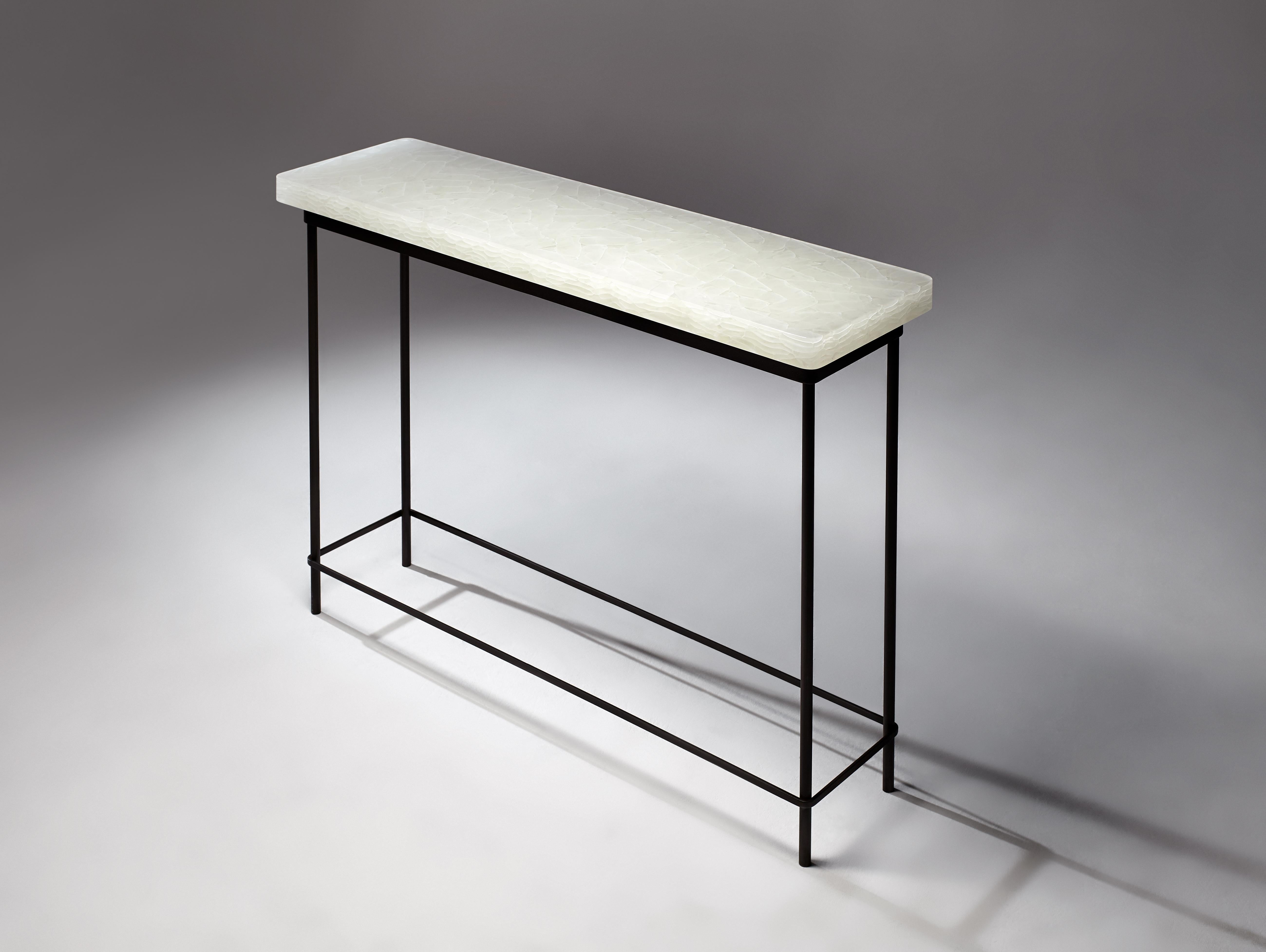 This Console table is hand made and polished in our small studio Toronto, Ontario by talented and seasoned craftspeople. The glass is borosilicate and is the same material found cladding the Baha'i' Temple of South America. The table base is made of