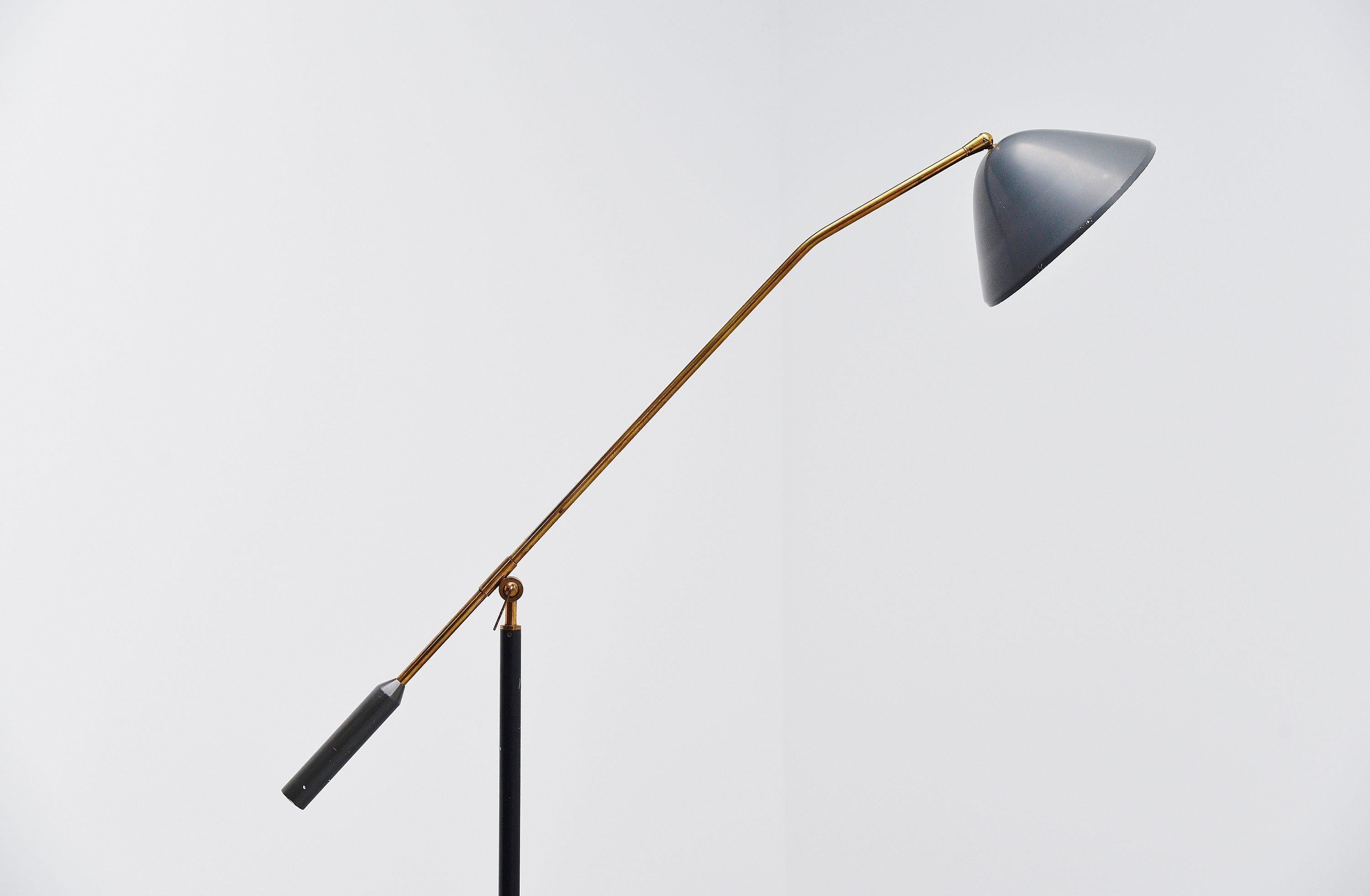 Adjustable standard lamp designed and manufactured by Stilux, Italy, 1960. The lamp has a round Carrara marble base and a black stem, with solid brass adjustable arm with very nice adjustment mechanism. The lamp has a dark grey shade and weighted