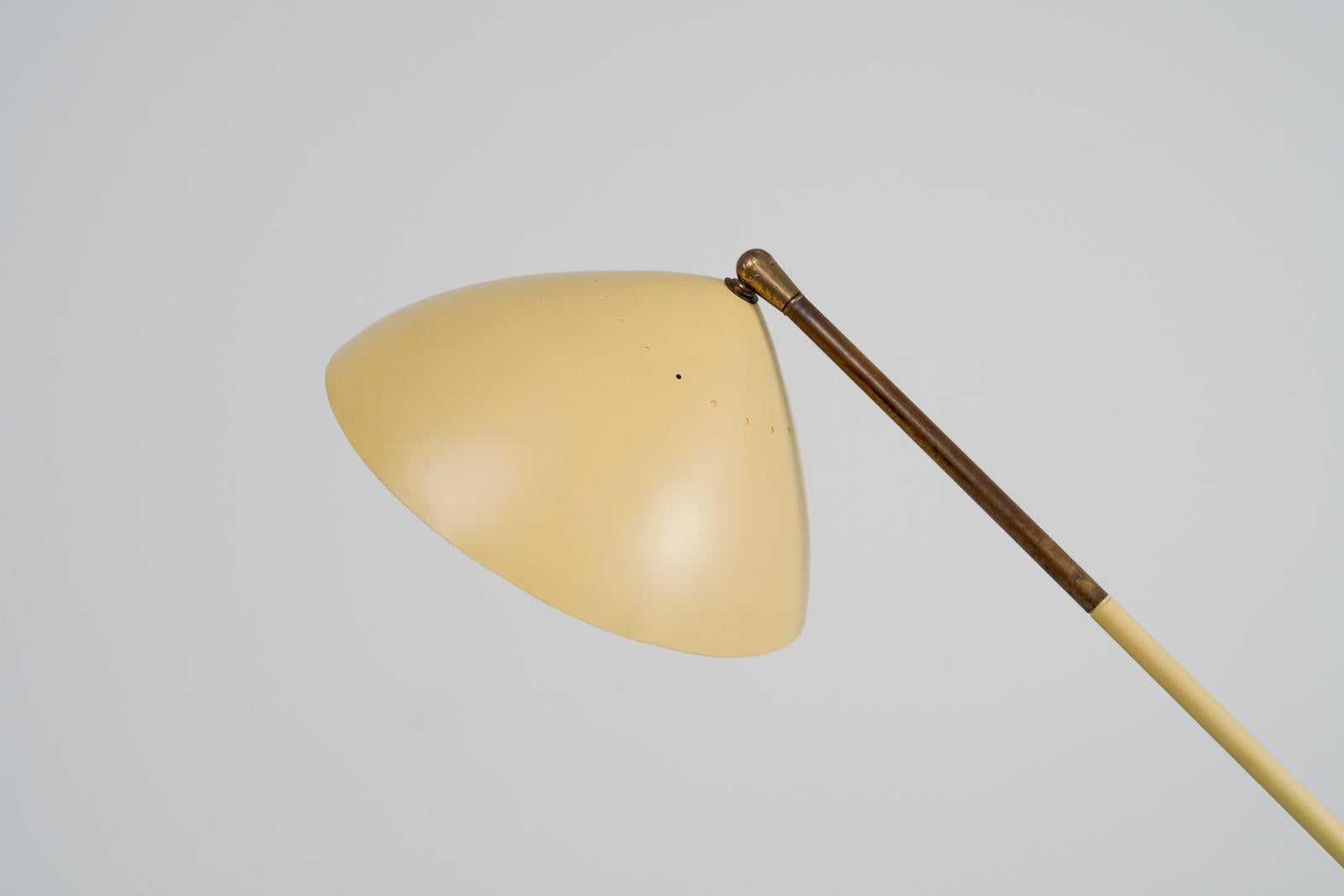 Very clean looking adjustable floor lamp by Stilux, made in 1960 in Italy. This progressive looking model has a round marble base, lovely patinated brass hardware details and a yellow shade which has professionally been refinished in it's original,