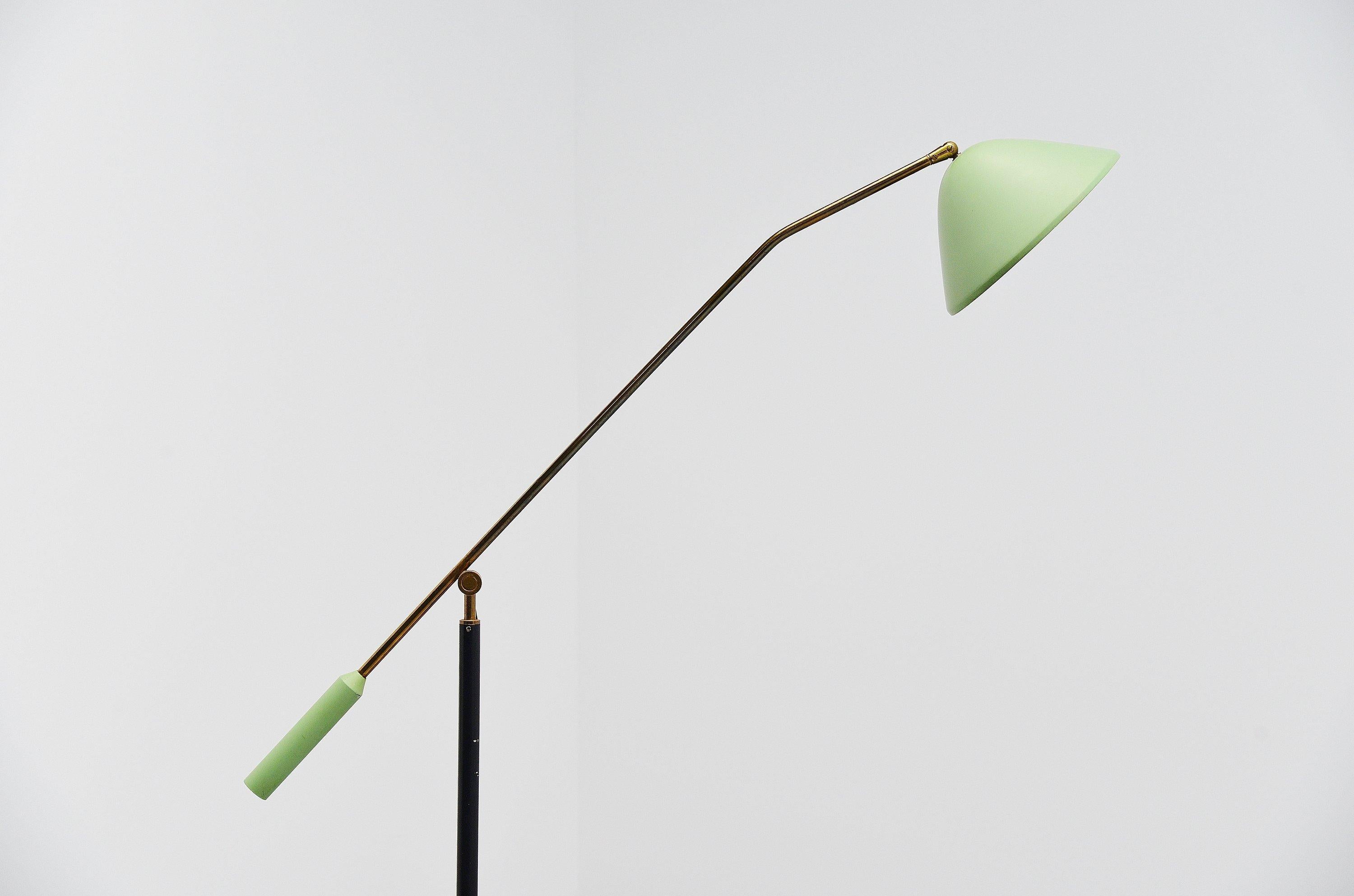 Adjustable standard lamp designed and manufactured by Stilux, Italy, 1960. The lamp has a round Carrara marble base and a black stem, with solid brass adjustable arm with very nice adjustment mechanism. The lamp has a mint green shade and weighted