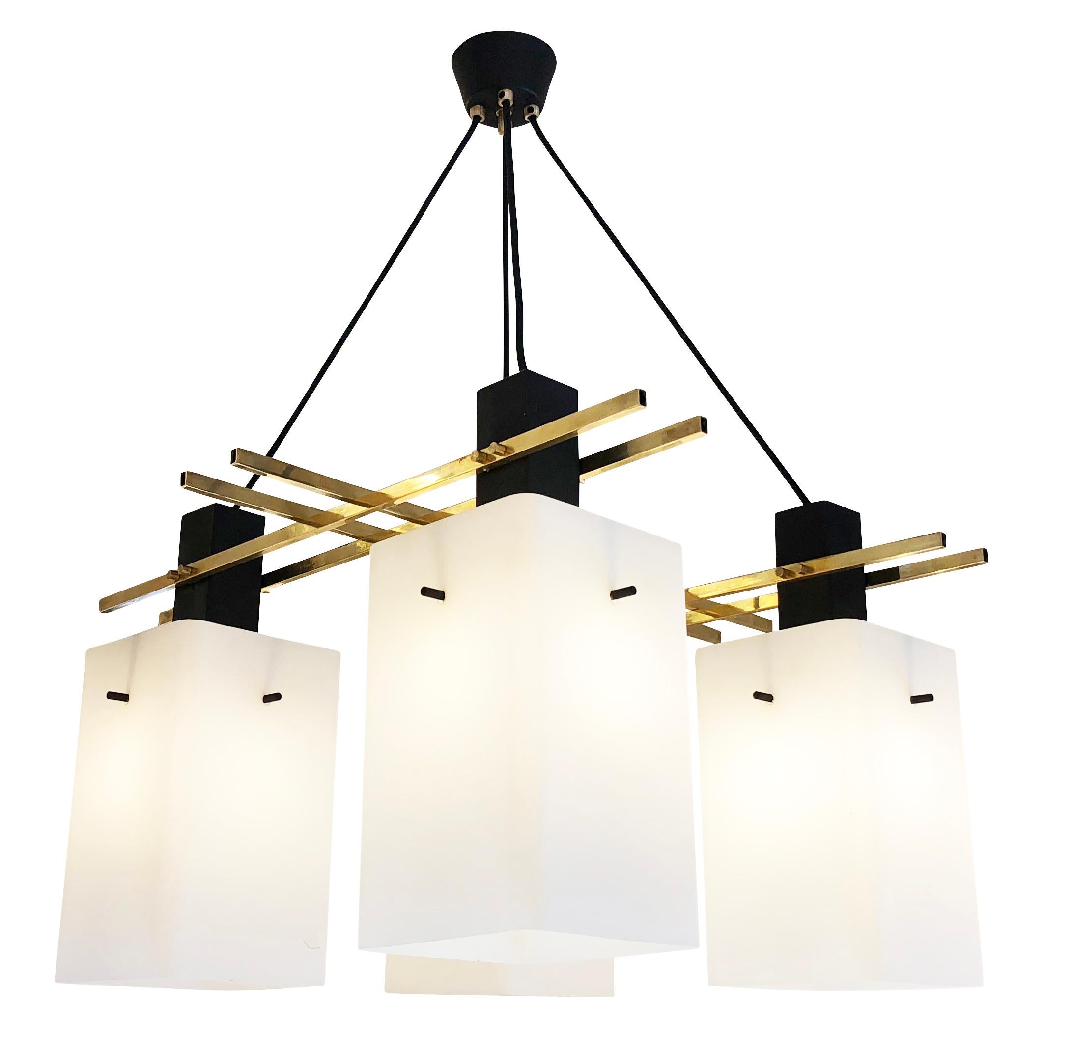 Stilux ceiling light with rectangular frosted glass shades on a brass frame with black lacquered details. Drop can be adjusted via the four fabric cords. Holds four candelabra bulbs.

Condition: Good vintage condition, minor wear consistent with