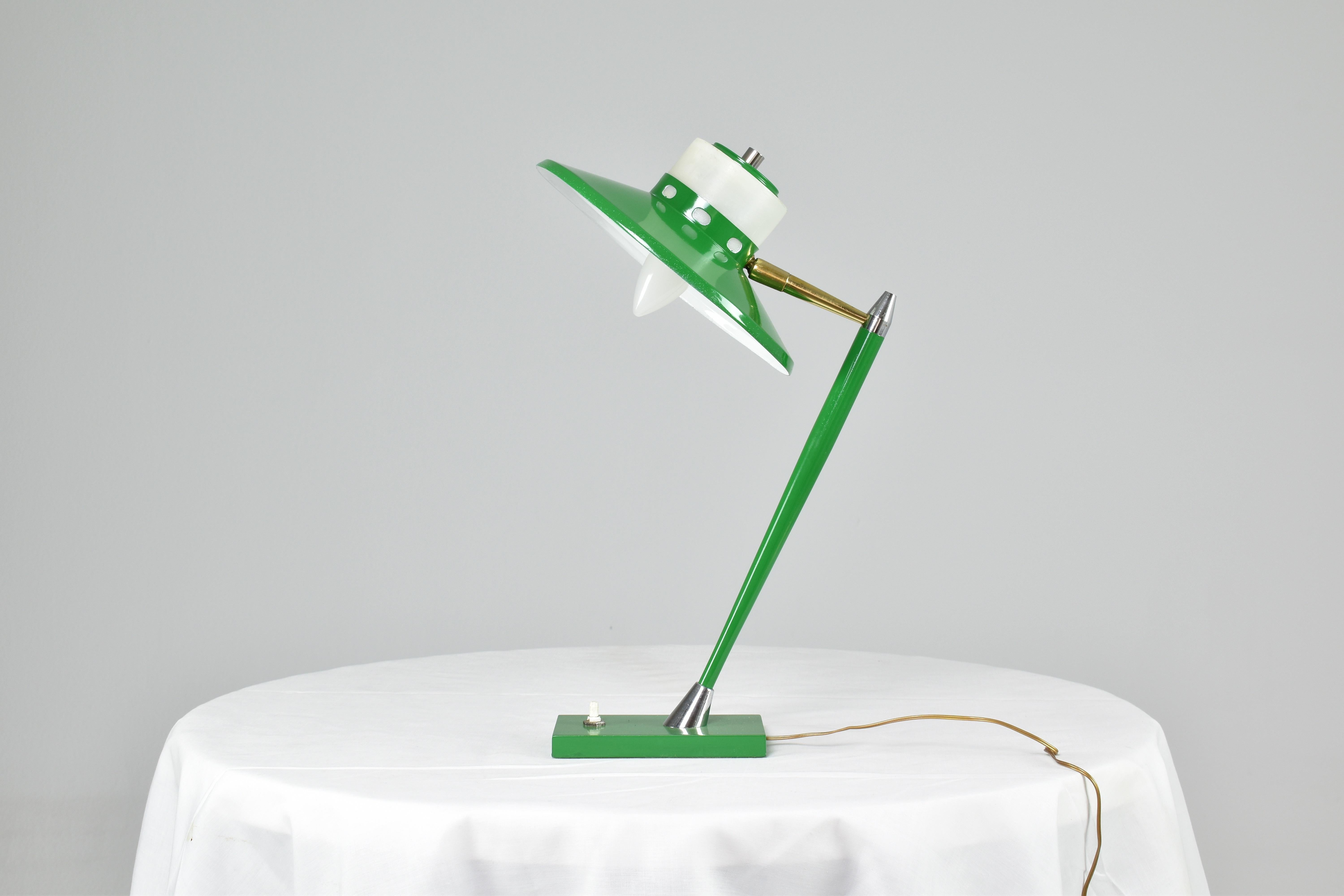 Stylish bright green Italian mid-century modern desk or table lamp by Stilux with adjustable shade and push type button at the base. This superb design is highlighted by brass and silver metallic details.
Italy. 1950s
The wire is new, plug is of