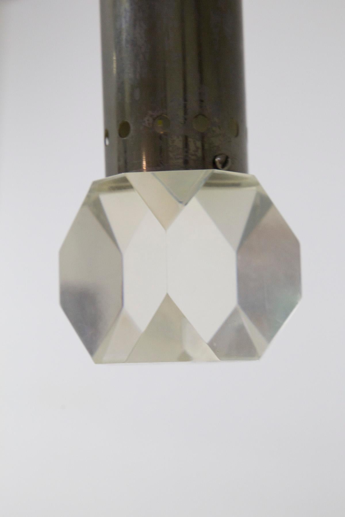 Beautiful pendant designed and produced by the fine Italian manufacturer Stilux in the 1950s.
The structure is made of durable aluminum and consists of an aluminum cylinder. 
The lamp ends with a glass bulb cover, worked to create diamond-like