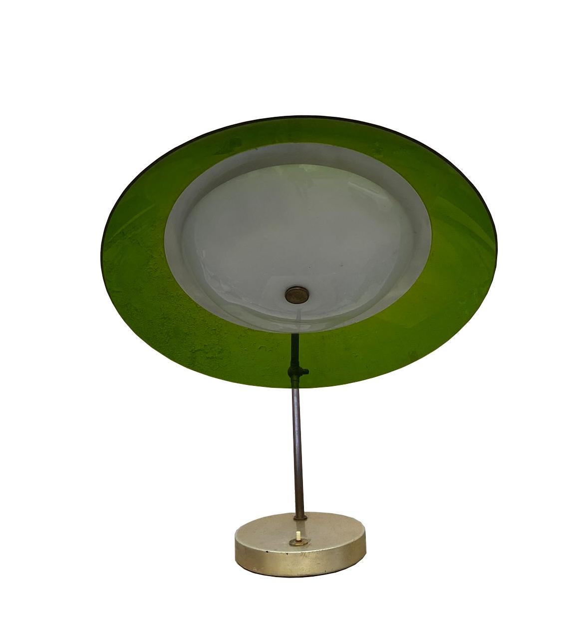 1950s Italian table lamp from Stilux Milano with brass base with switch and green plexi dome reflector which can be playfully positioned from the articulating arm which has two adjustable joints. 
The diffuser is slightly deformed