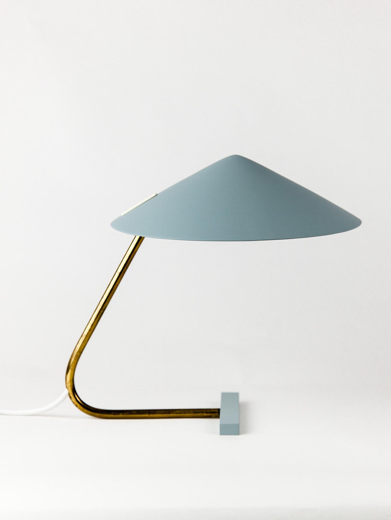 Vintage Italian table lamp by Stilux Milano with an aluminum shade and solid brass details. Its sleek modernist lines and grayish-green coloring epitomize Italian mid-century design and is as sculptural as it is functional. The lampshade pivots up
