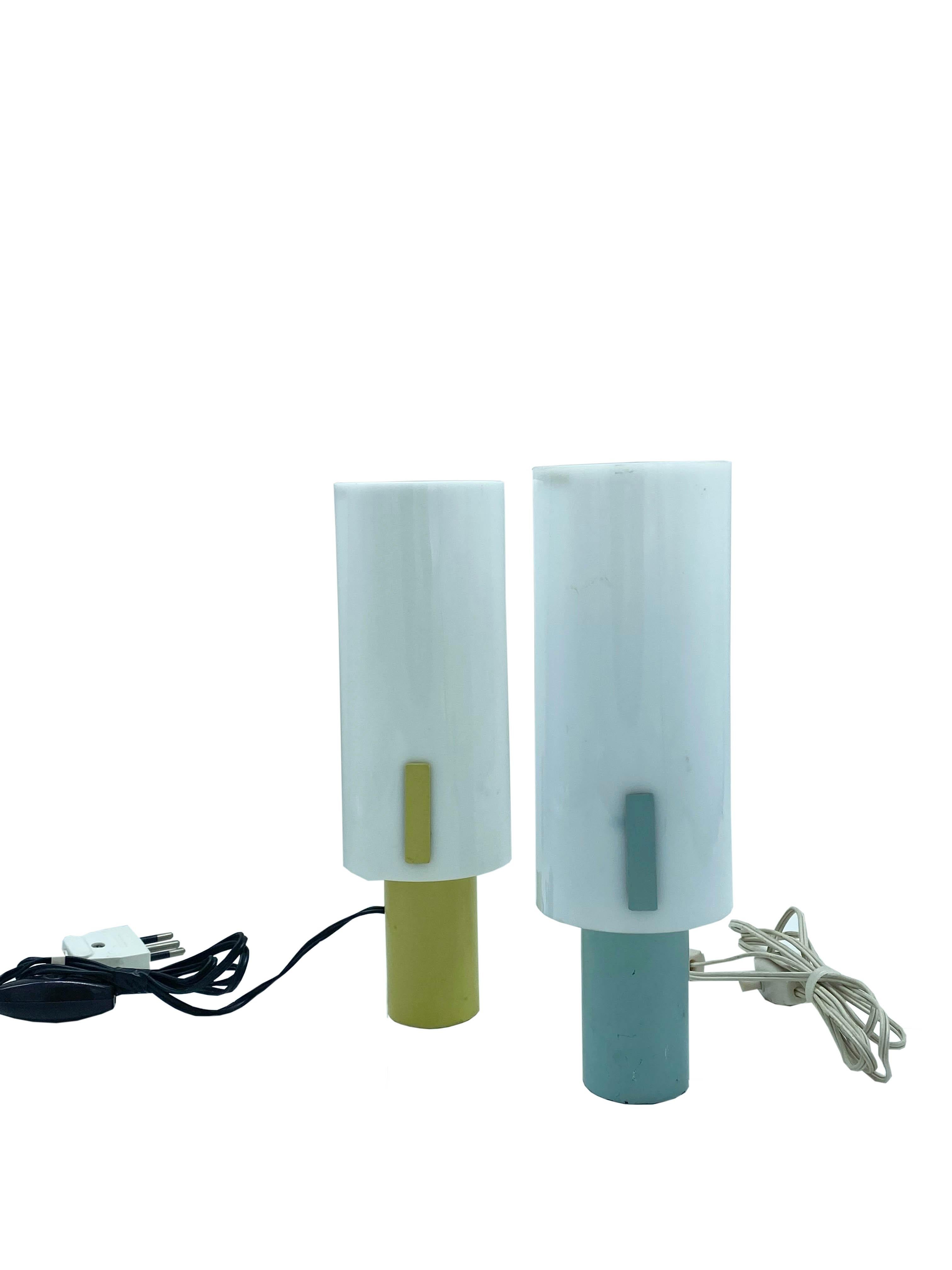 This Mid-Century Modern table lamps were manufactured by Stilux Milano in the 1960s.
They are made of cream Perspex, one of green painted metal and the other of yellow painted metal.