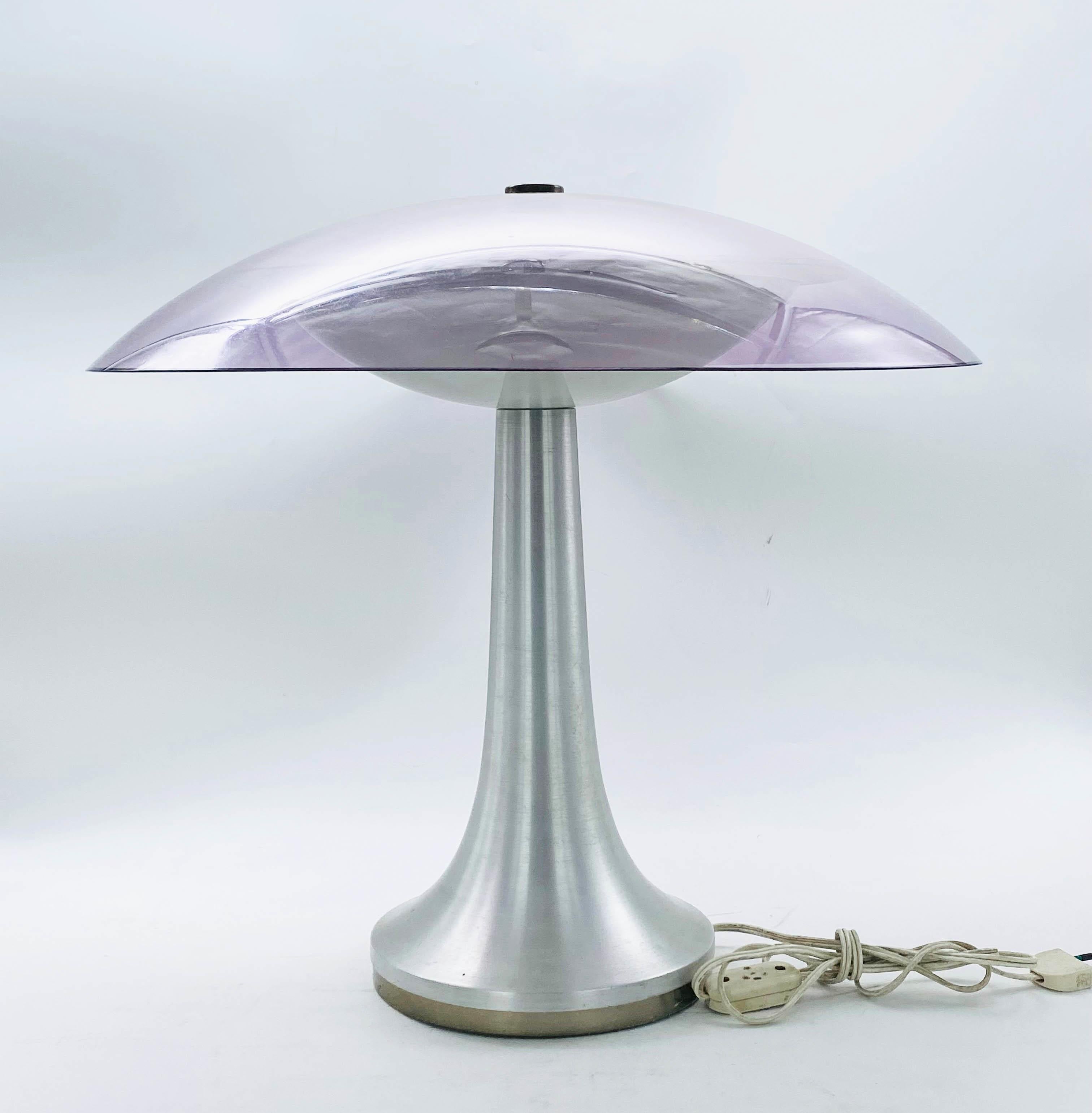 A table lamp with a brushed aluminium base and mauve plexiglass diffuser, the lamp was designed in the 1960s and produced by the prestigious Stilux Milano in Italy.