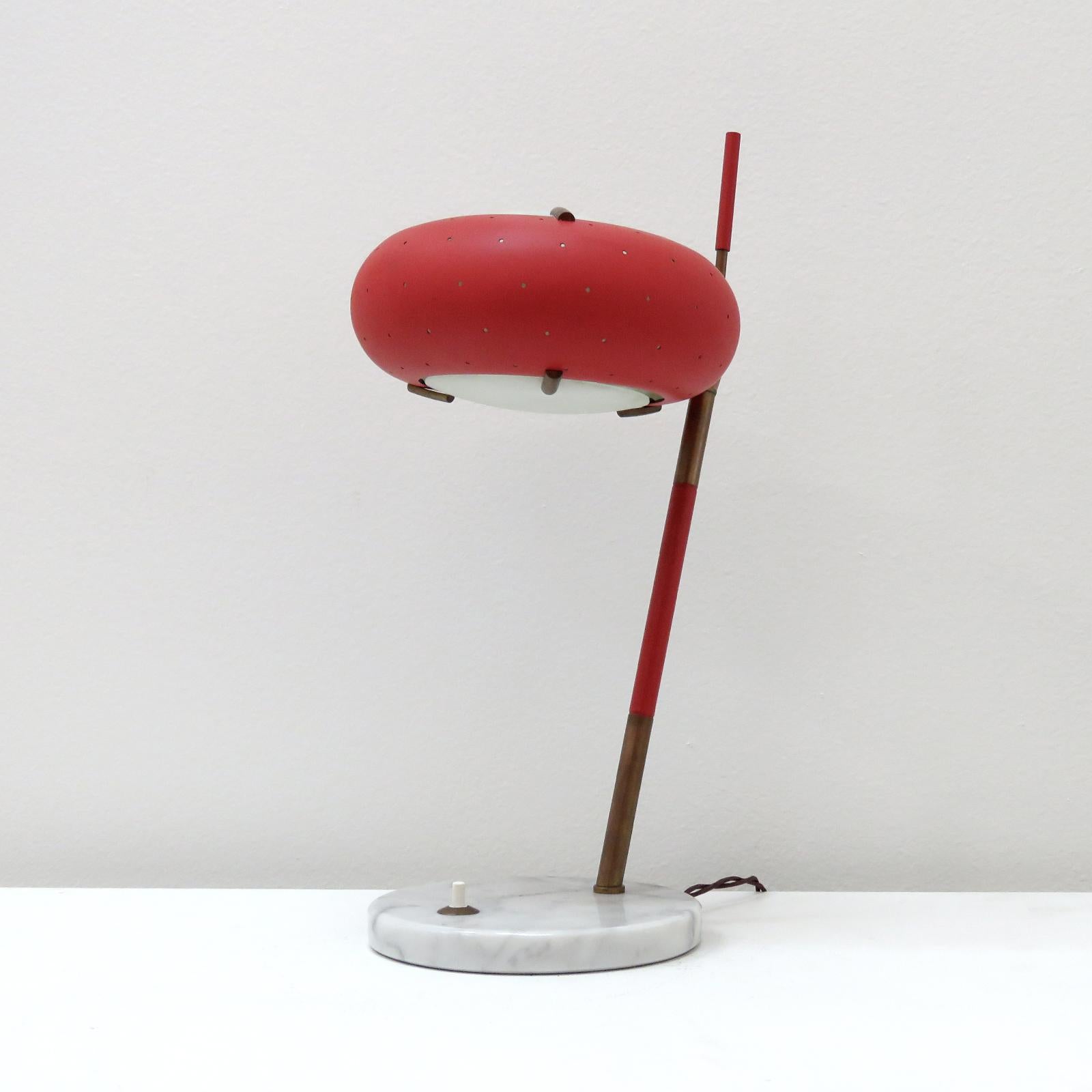 wonderful, midcentury table lamp by Stilux Milano, Italy, with patinaed, partially wrapped brass post on a Carrara marble base, with articulate, beautifully perforated red metal shade. A bottom and top diffuser of frosted glass are held in place by