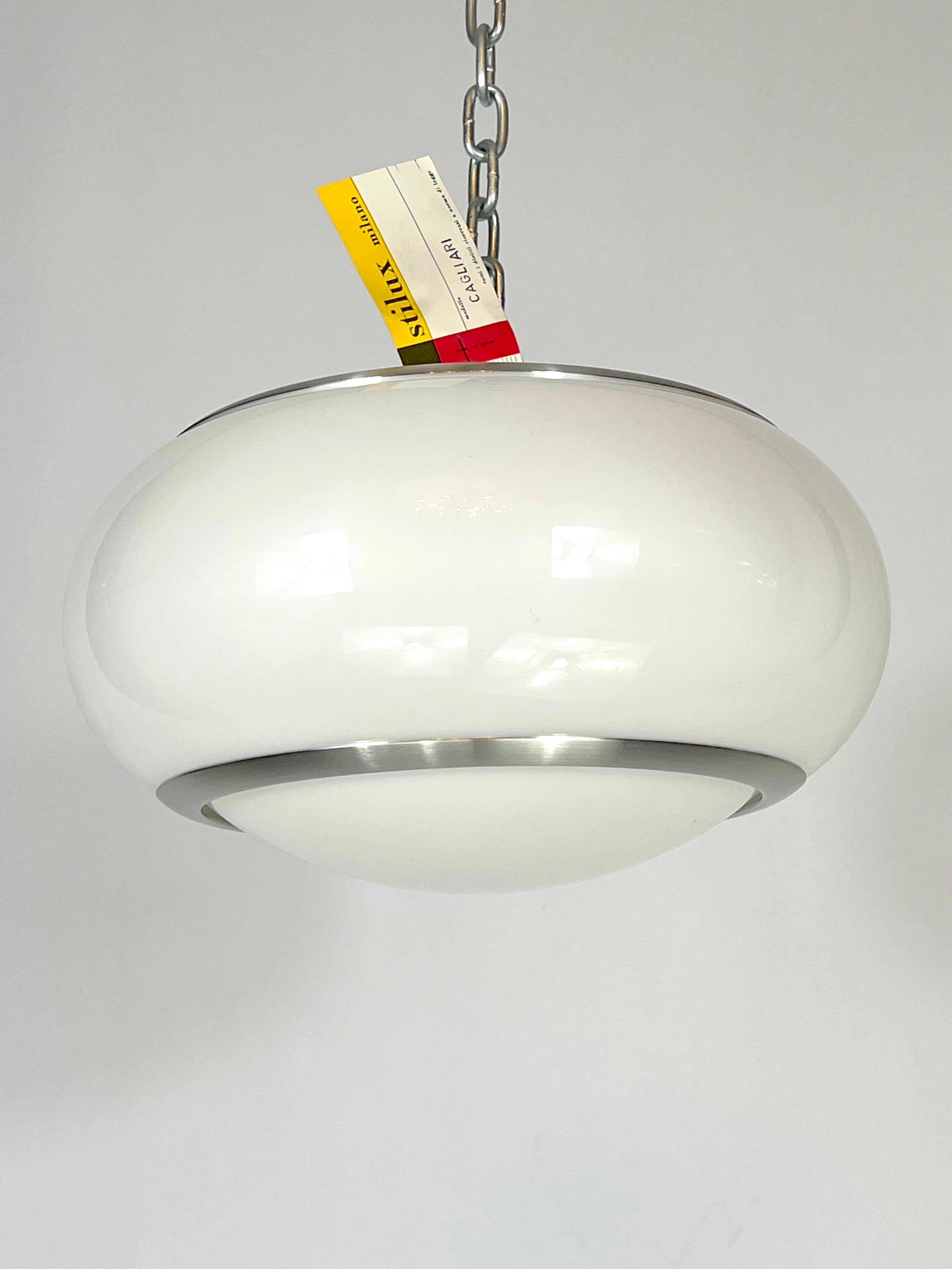 Exeptional condition for this stock fund ceiling lamp produced by Stilux Milano and made from brushed aluminum and perspex. Original label and tag of manufacturing. Full working with EU standard, adaptable on demand for USA standard.