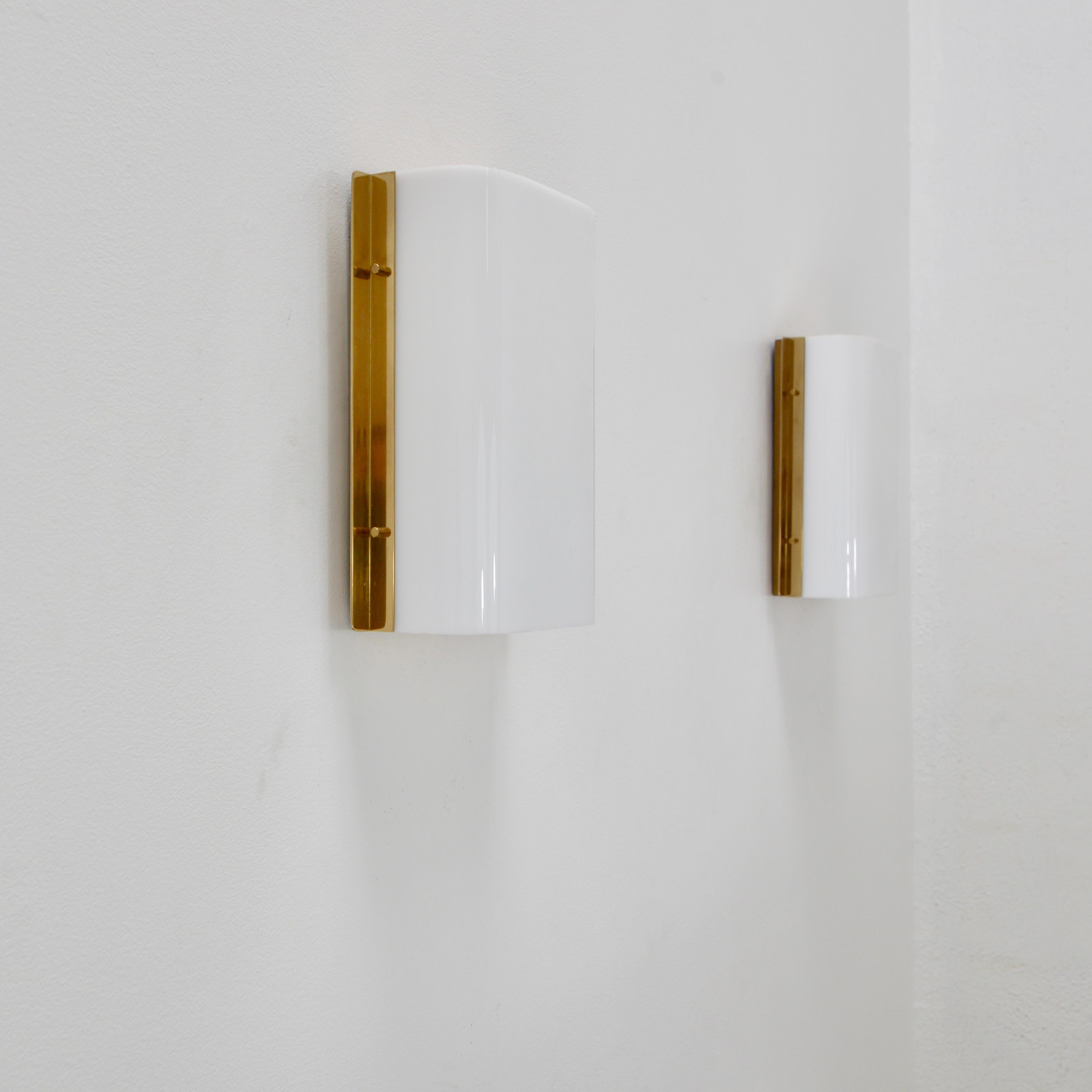 Elegant pair of Italian rectangular sconces from the1950s by Stilux. In brass, aluminum and acrylic Naturally aged. (2) E26 medium based sockets per sconce. Priced as a pair. Wired for use in the US. Lightbulbs included with