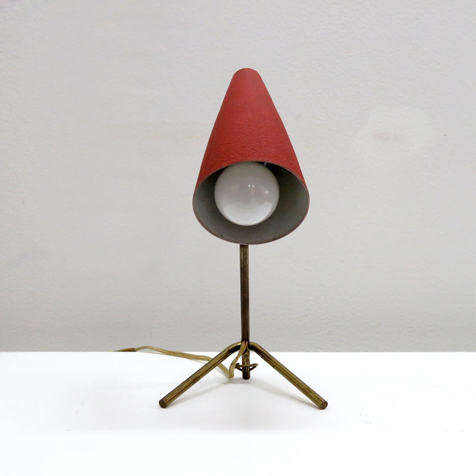 wonderful, petite table lamp by Stilux with patinaed brass frame and original, articulate red enameled shade, can be used as wall light as well. Wired for US standards, one E12 socket, max. wattage 60w or LED equivalent, bulb provided as a onetime