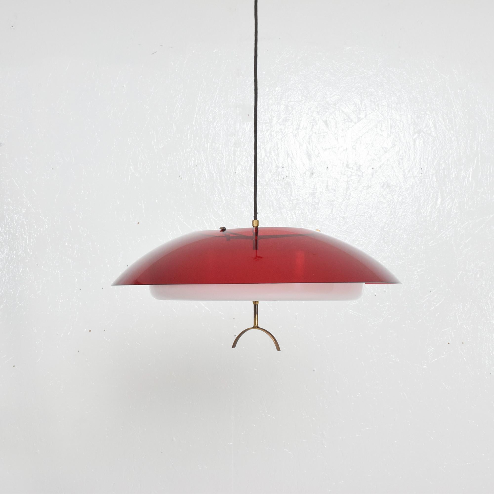 Stilux modern hanging dish pendant ceiling light fixture made in Milan, Italy, circa 1960s.
Two tone molded plexiglass white and translucent red with patinated brass hardware.
Dimensions: 6