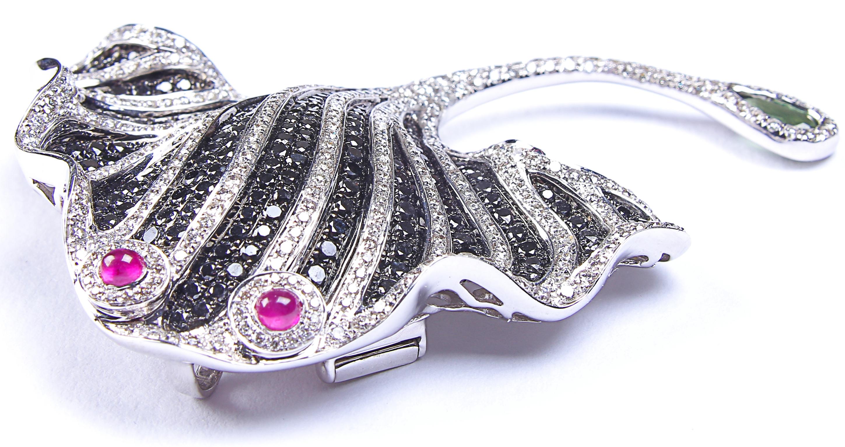 An unusual and spectacular marine piece; designed to be worn either as a brooch or a pendant. This stunning stingray or manta ray is created from 18 karat white gold and stamped 750. There is a covering of pave-set black gemstones, edged and striped