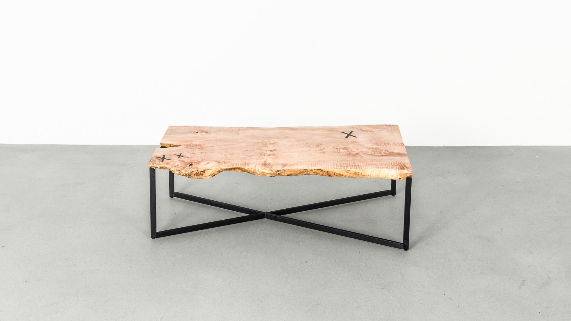 The Stitch coffee table showcases the rich grain of gorgeous Big Leaf Maple slab. Each coffee table embraces walnut's naturally occurring checks, which are reinforced with X-shaped brass stitches. The inset stitches beautifully contrast the tones of