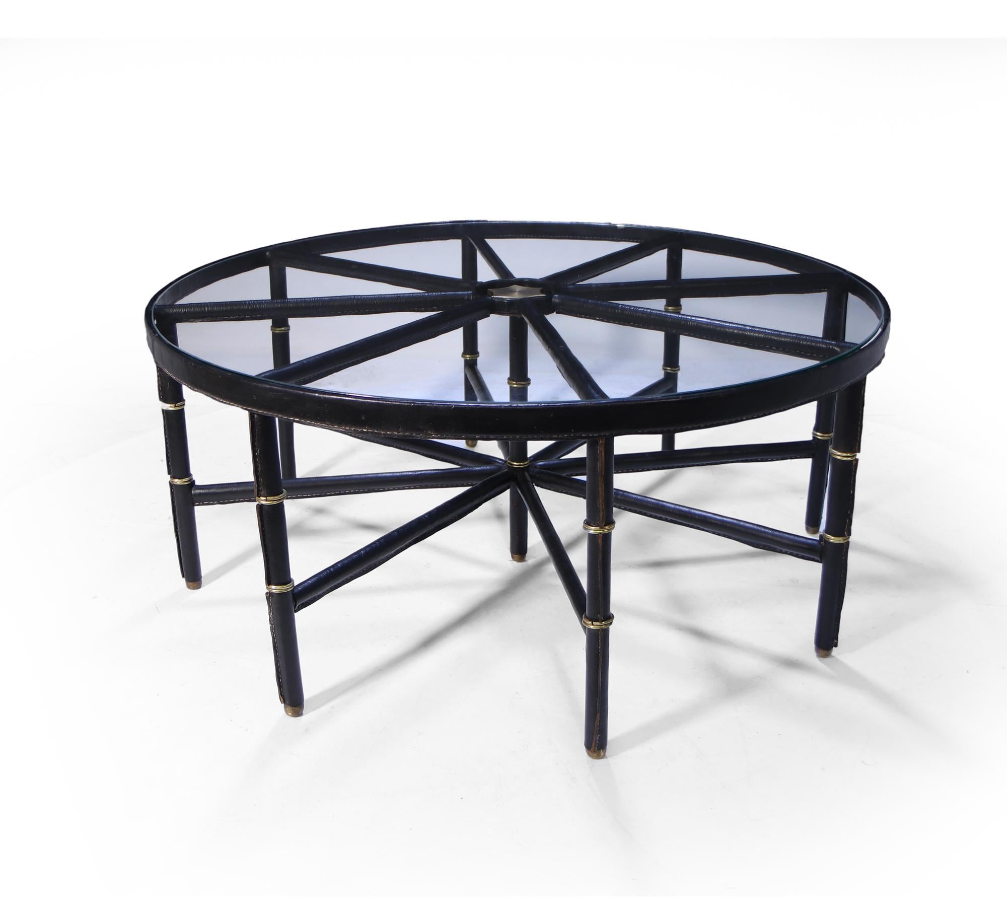 Stitched leather and brass table by Jacques Adnet

A stitched black leather and brass table with eight legs, in very good condition with a few scuffs to the leather here and there, this table appears on the front page of The Jacques Adnet book
