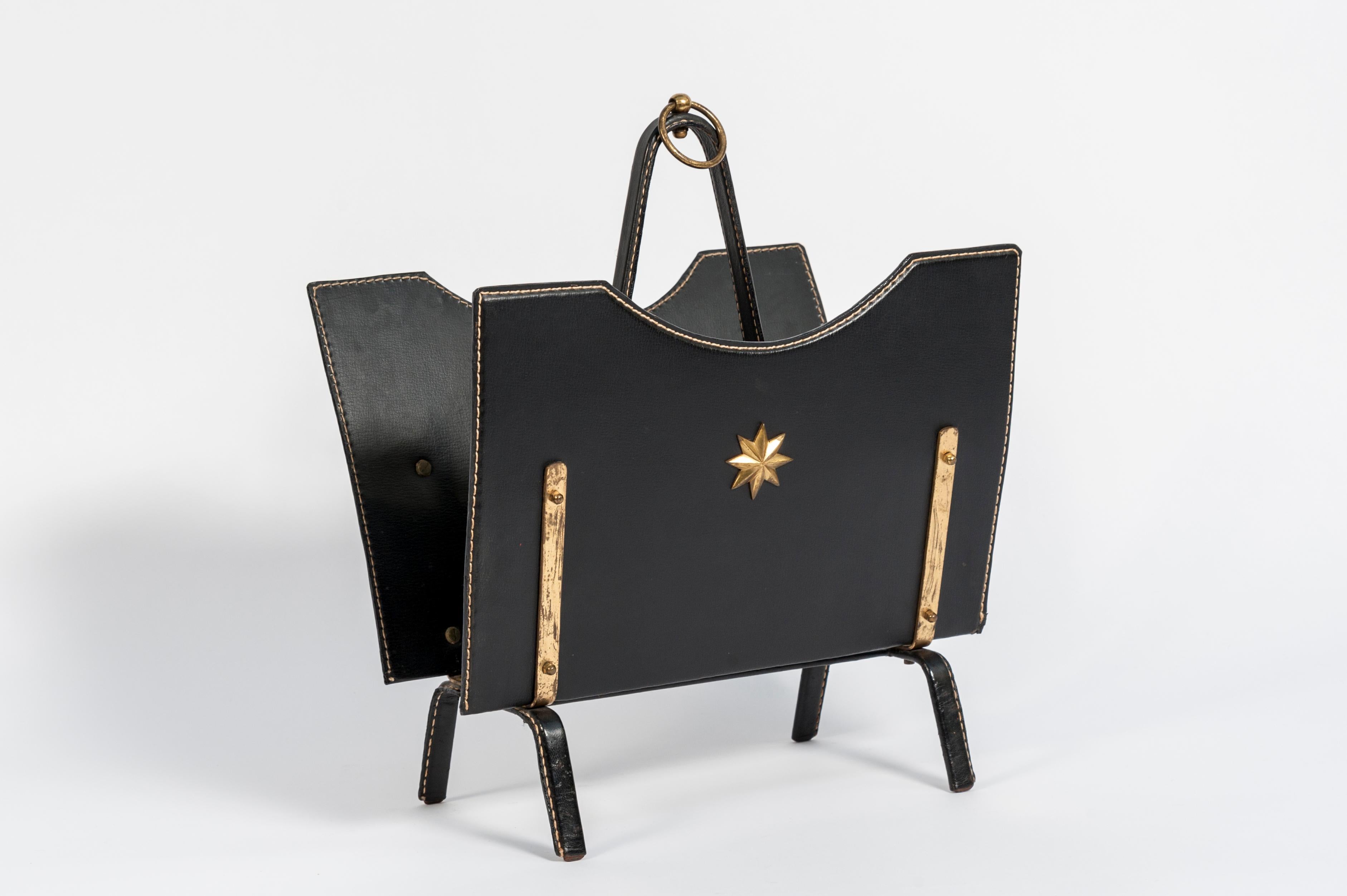 Perfect condition magazine rack by Jacques Adnet.
 