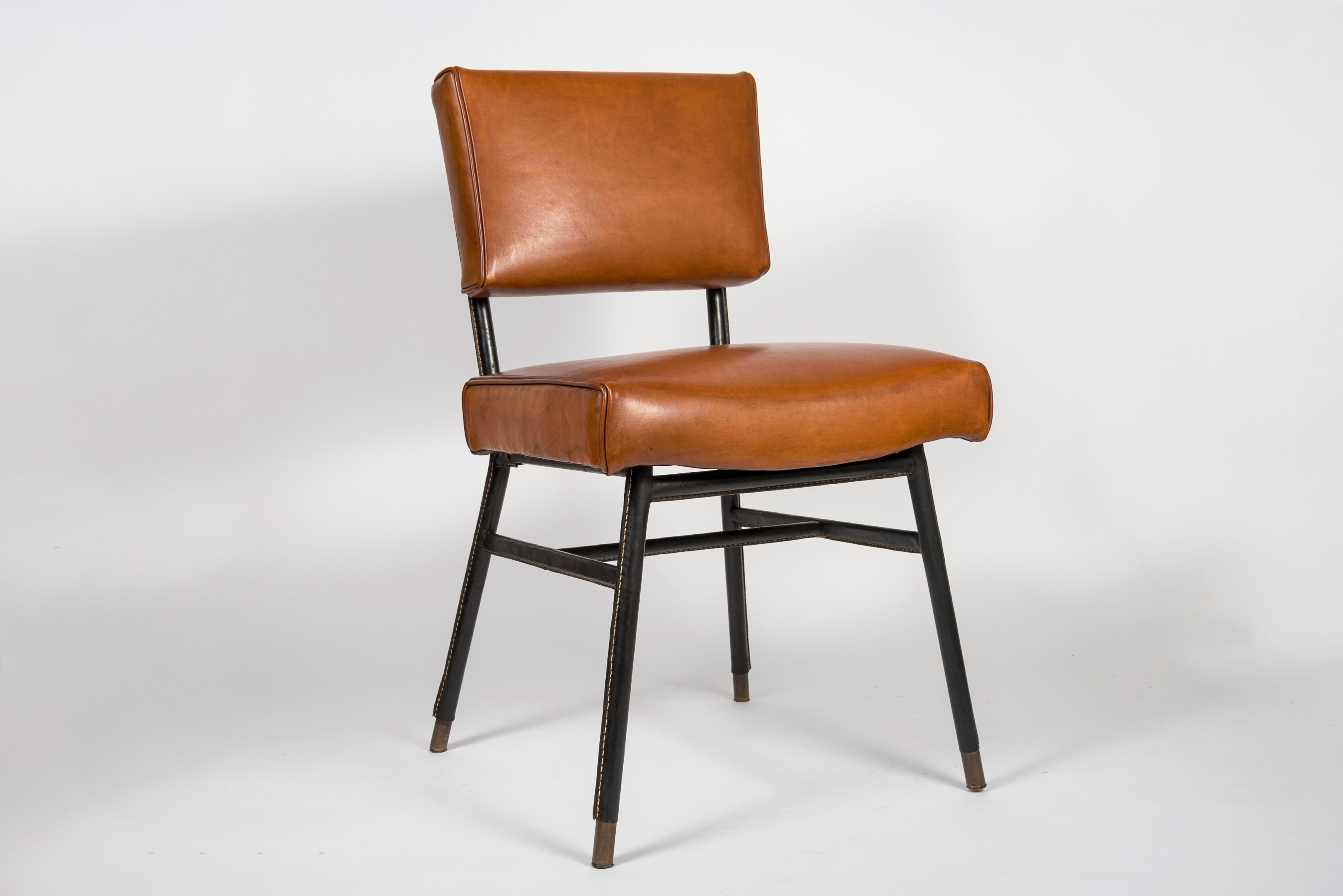 Very nice pair of stitched leather chairs by Jacques Adnet.
        