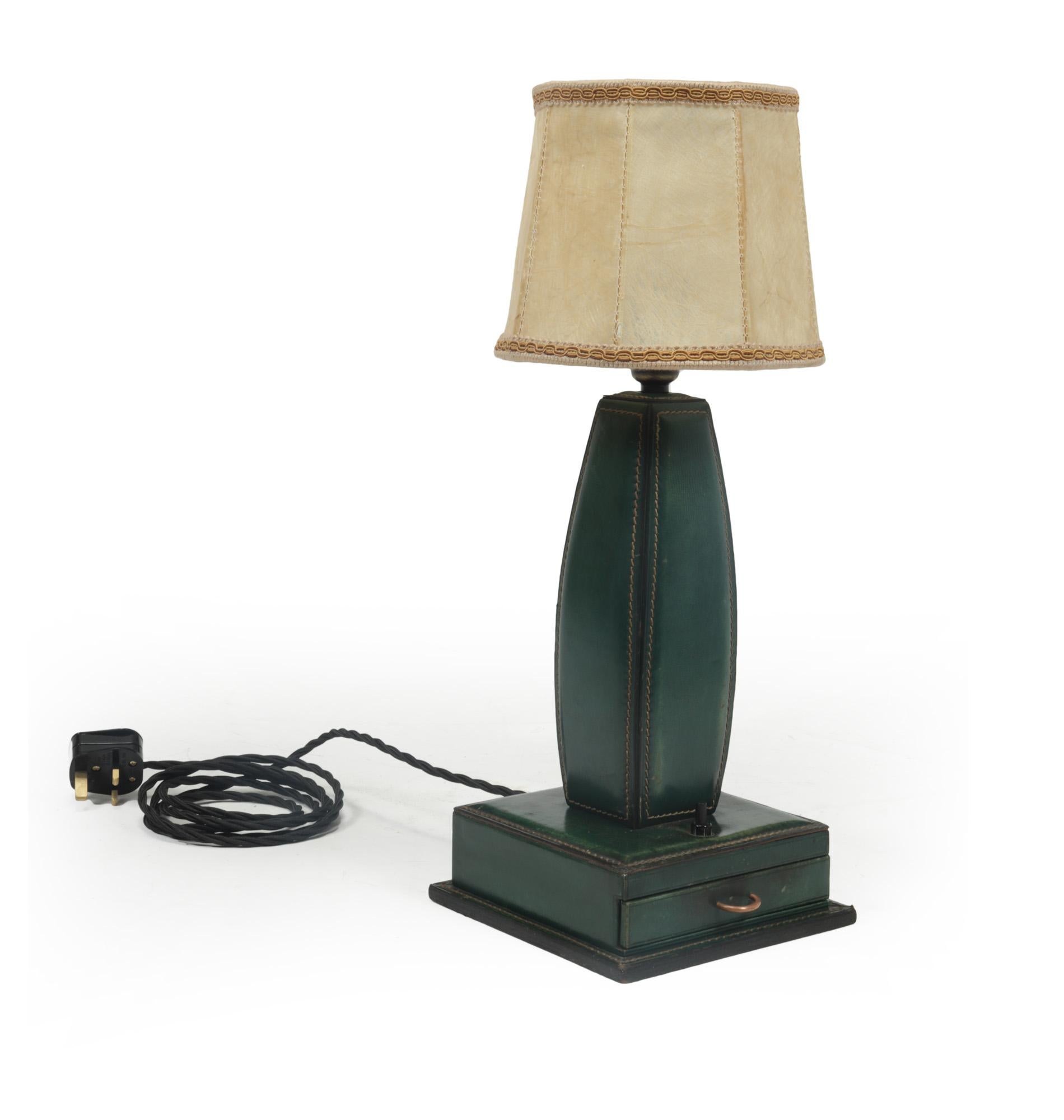 Stitched leather table lamp by Jacques Adnet France 1950
A table lamp by Jacques Adnet, produced in France in the 1950’s from beautifully patinated green stitched leather and fixed to wooden structure, having a drawer in the base with a brass