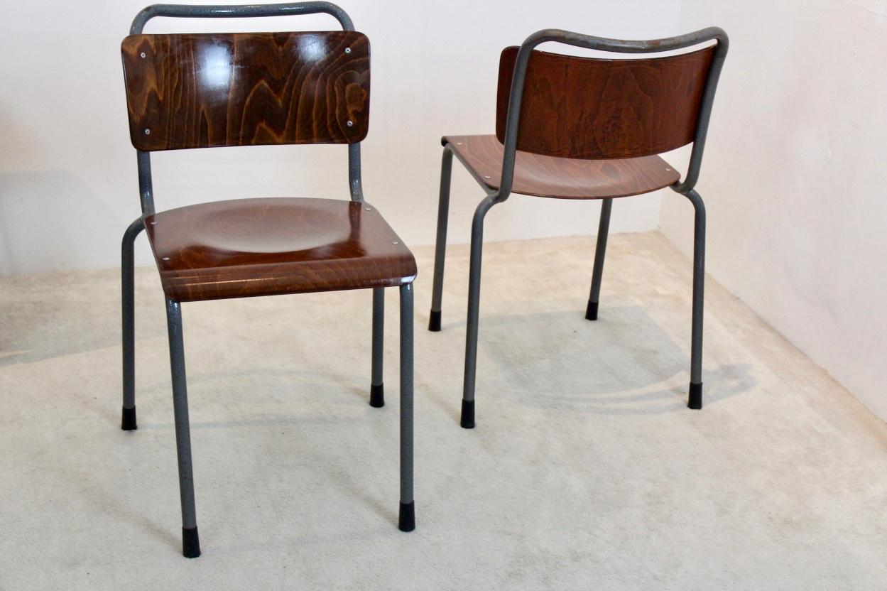 Beautiful industrial chairs designed by W.H. Gispen. Featuring a solid ‘hammered’ grey steel tubular frame and brown Pagholz plywood seat and backrest. With normal wear in very good vintage condition. Sixteen chairs available with a great sit. This