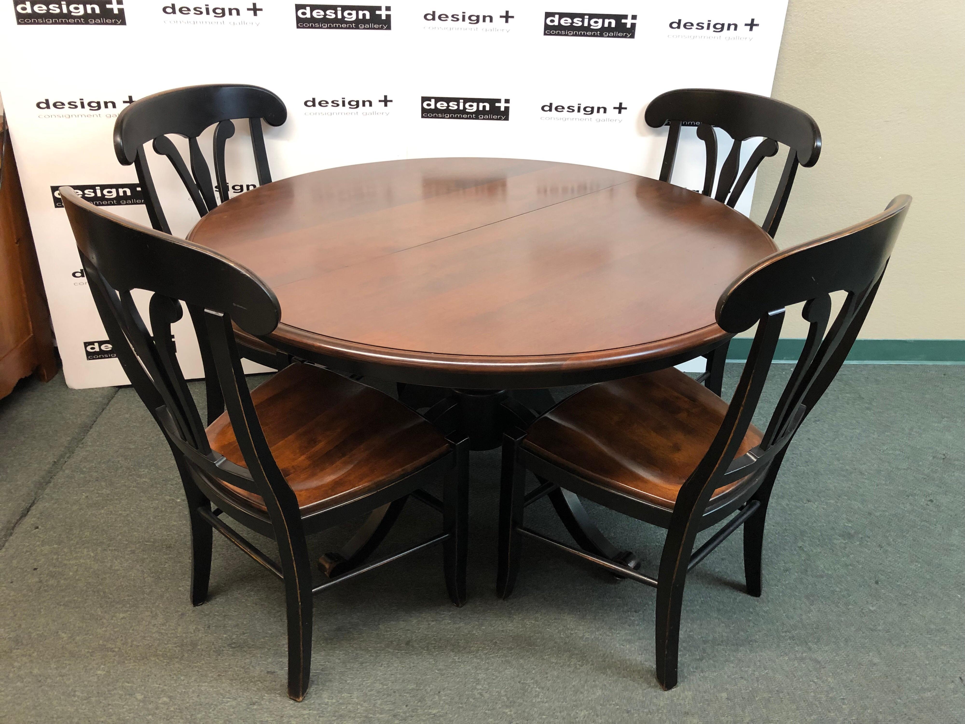 A Nichols & Stone Dining Set. Olde World styling, with a wood grained top and darkly contrasting pedestal base, the table expands with a 20 inch leaf. The company's famous steam bending to makes these chairs quite comfortable, crafted from Solid