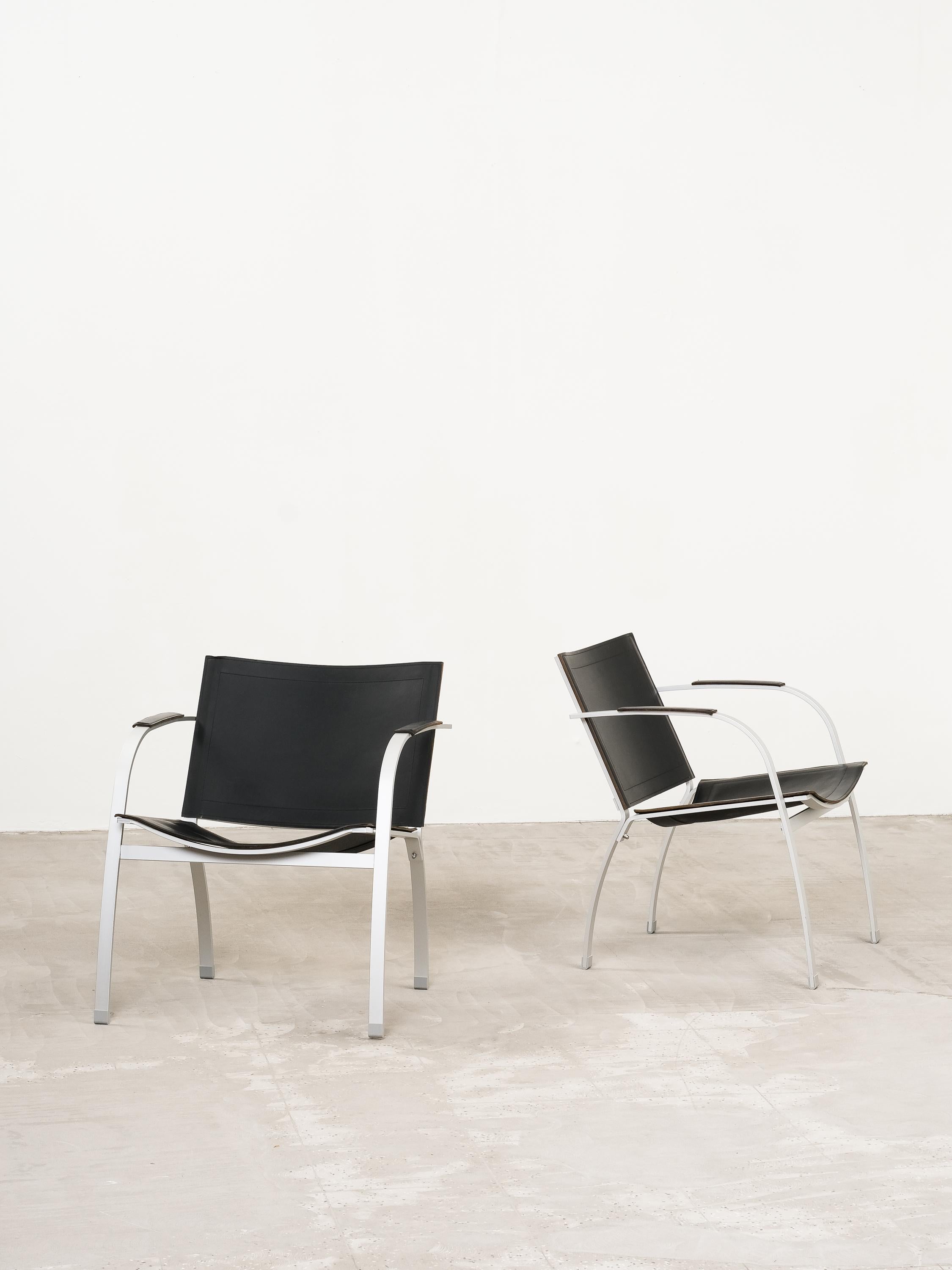 Postmodern vintage design aluminum armchairs with a black leather seat and backrest, ca 1990s. Chair model 