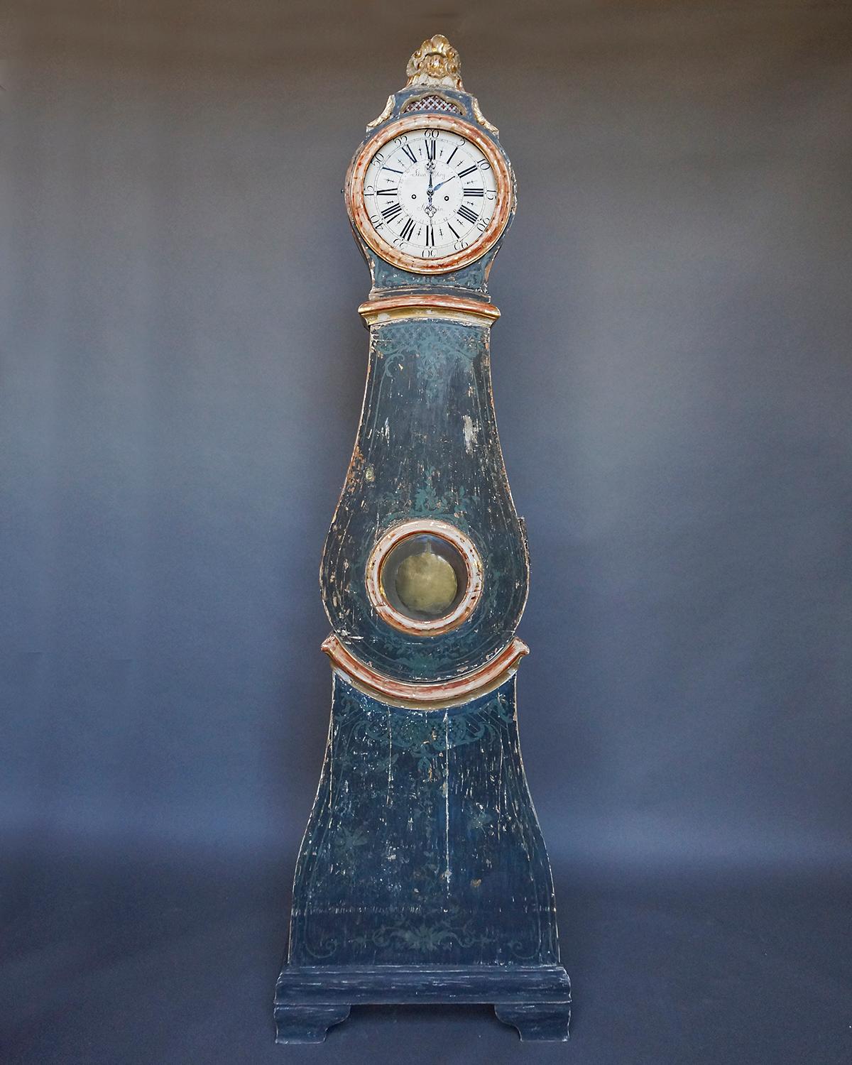 Swedish tall case clock by Johan Nyberg, master clock maker active in Stockholm from 1787 to 1801. The clockworks are more advanced than most examples from the period, having an integral calendar and a signature on the beautifully painted dial. The
