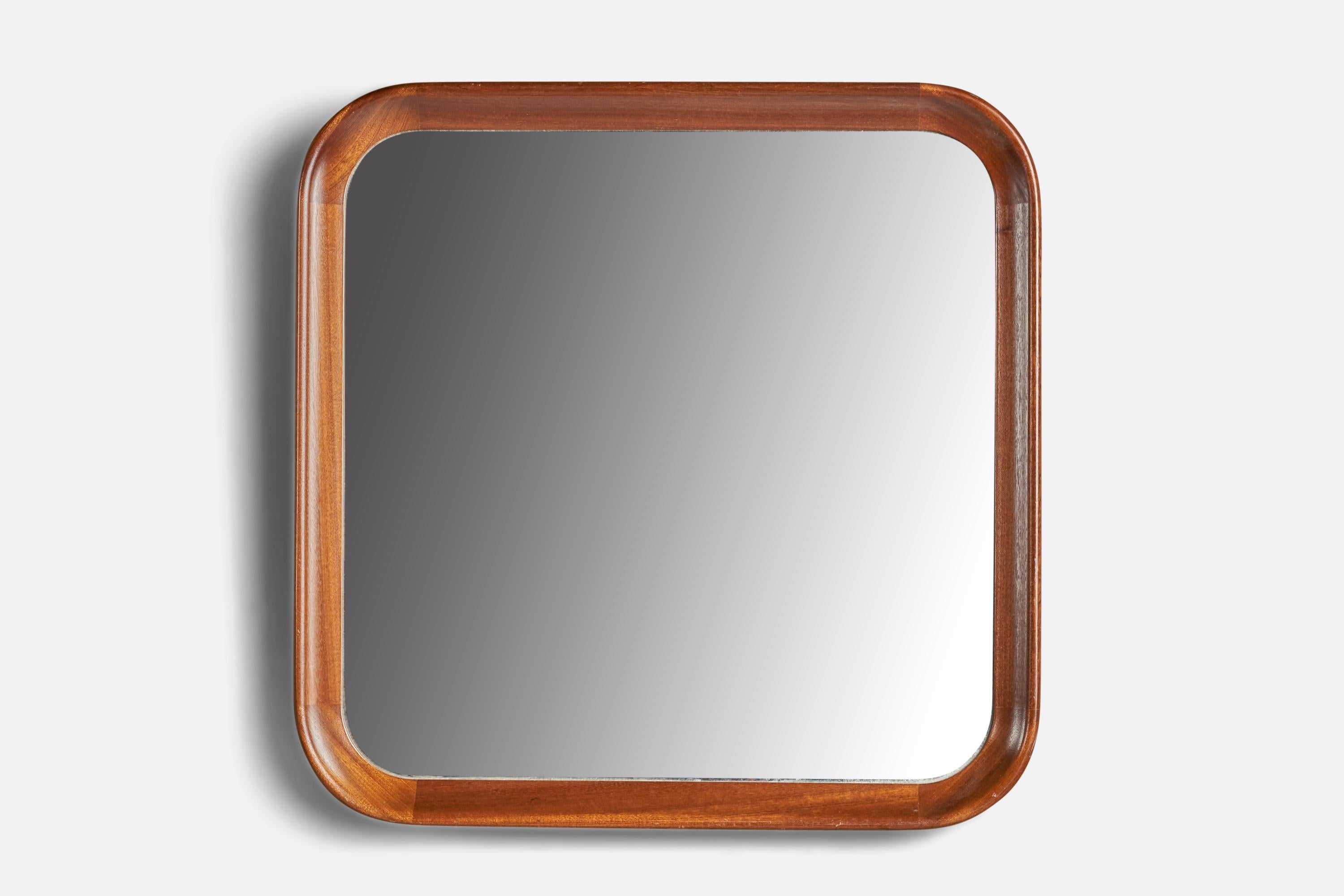 A solid oak wall mirror designed and produced by Stockmann OY, Finland, c. 1950s.