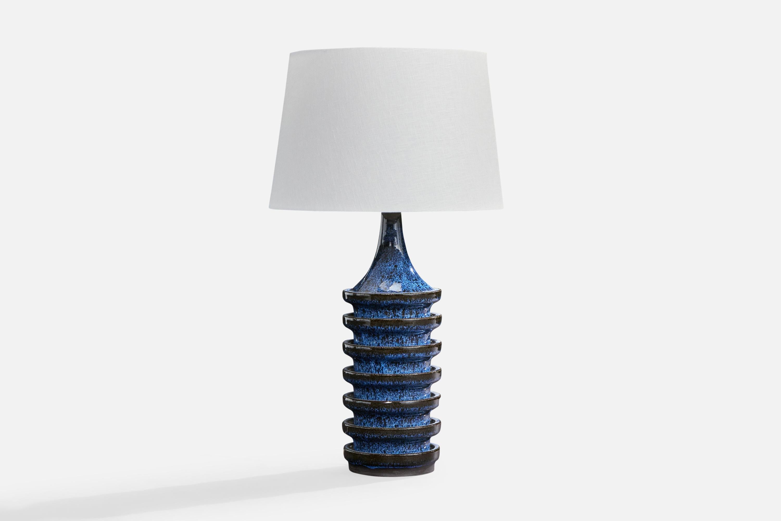 A blue-glazed stoneware table lamp produced by Stogo, Denmark, c. 1960s.

Dimensions of Lamp (inches): 16.125