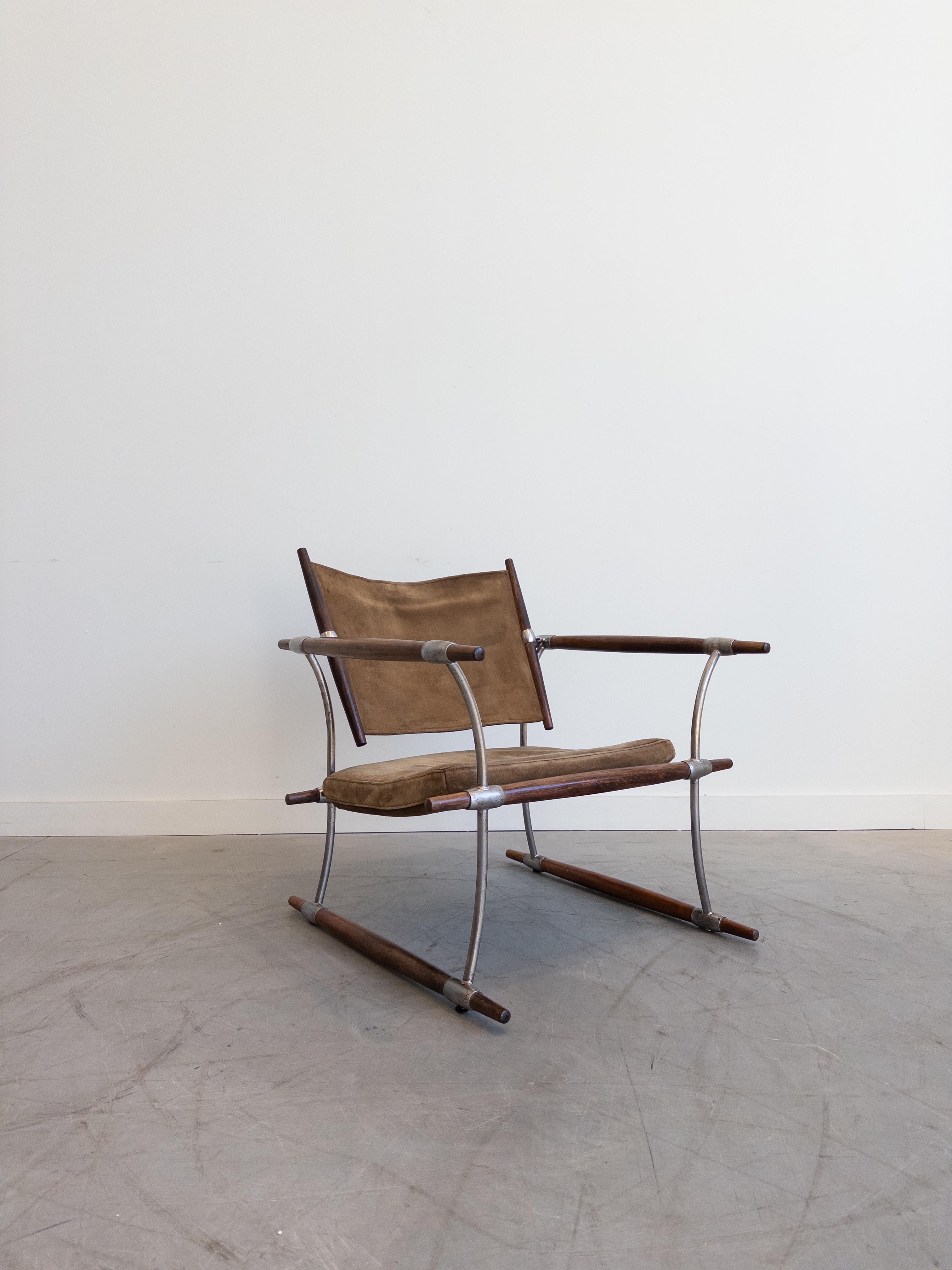 'Stokke' lounge chair by Jens Harald Quistgaard for Nissen Langaa, Denmark, designed and produced in the 1960s. The 'Stokke' chair features Rosewood rails held together with chrome plated steel bars and hooks. The seat slings and cushion are its