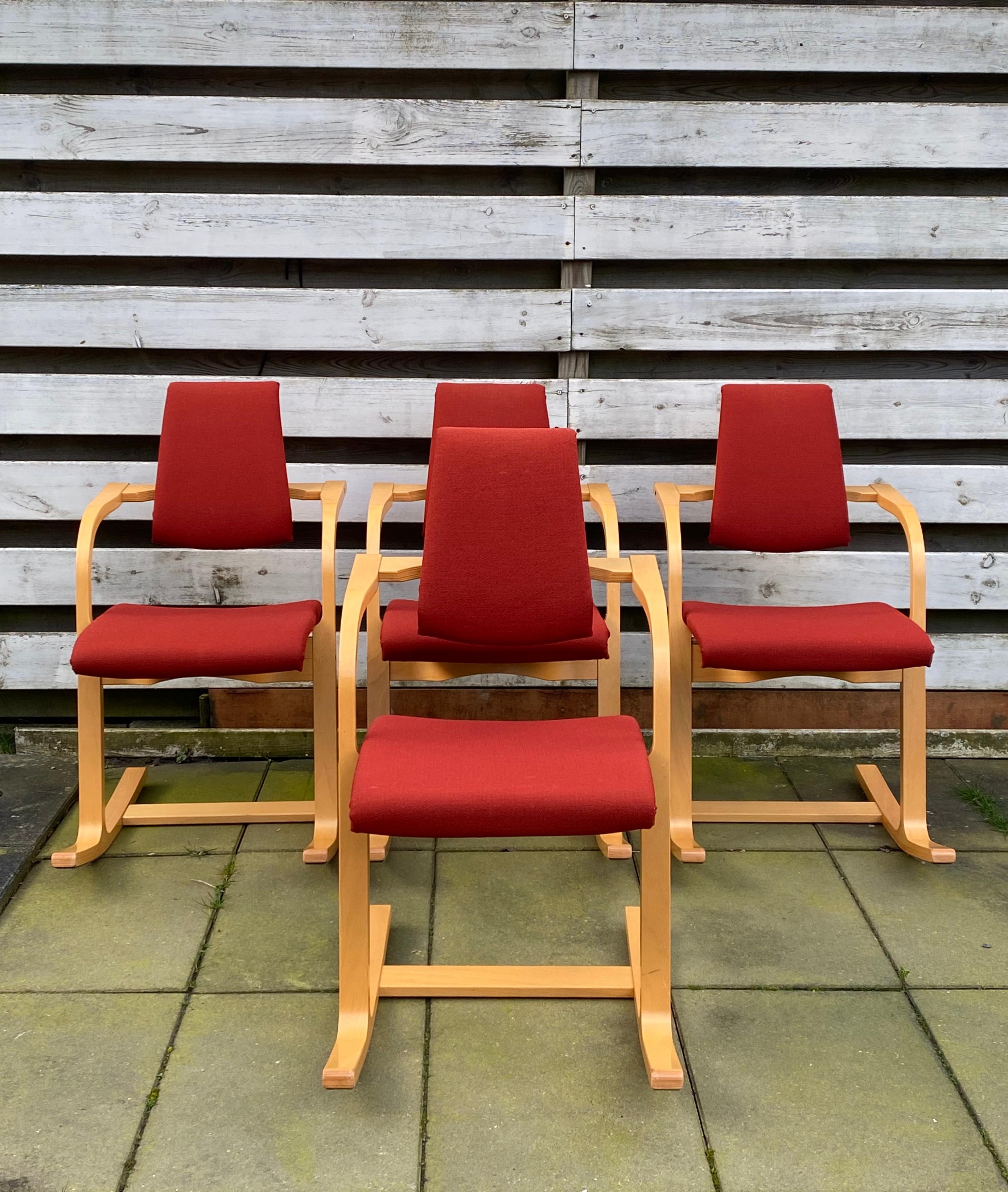 Scandinavian pieces, designed by Peter Opsvik, who also designed the Iconic Tripp Trapp chair for children, and manufactured by Stokke in 2005. The chairs feature a Beech base and deep red fabric. They remain in very good condition, with wear