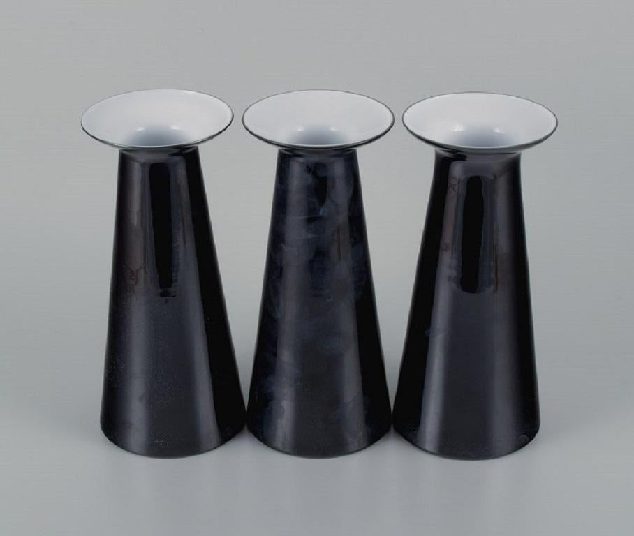 Stölzle-Oberglas AG. Three art glass vases, model 'Beatrice' and 'Nora'.
Austria, 1980s. 
Cylindrical body with a long neck and wide opening, black glazed, matted and speckled.
In perfect condition.
Dimensions: H.25.5 cm x D.11cm.