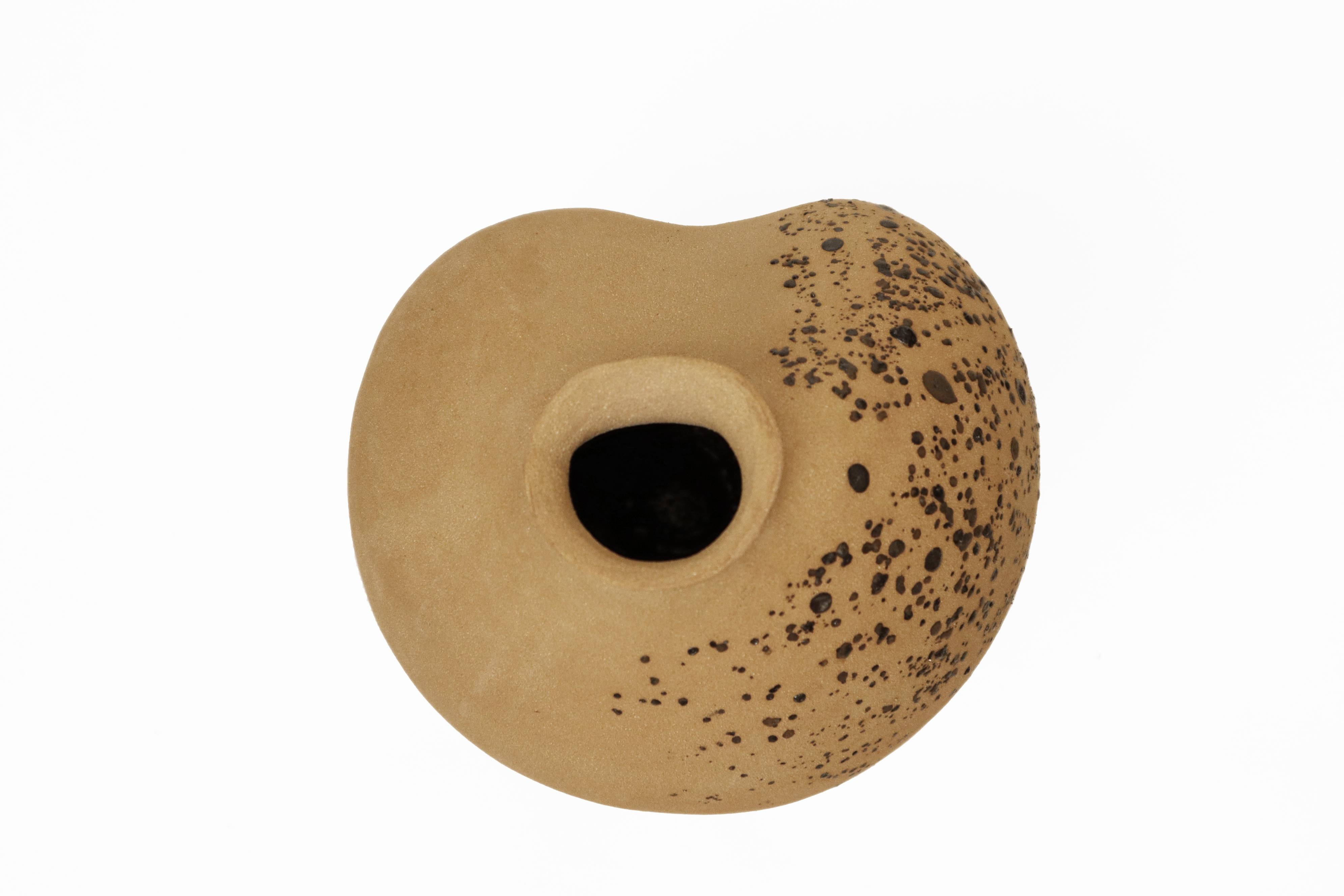 Stomata 14 vase by Anna Karountzou
Dimensions: W 22 x D 24 x H 34.5 cm
Materials: Beige stoneware clay, clear glaze inside, decorated outside with volcano rocks collected from Santorini, fired at 1240

Born and based in Athens, Greece, with a