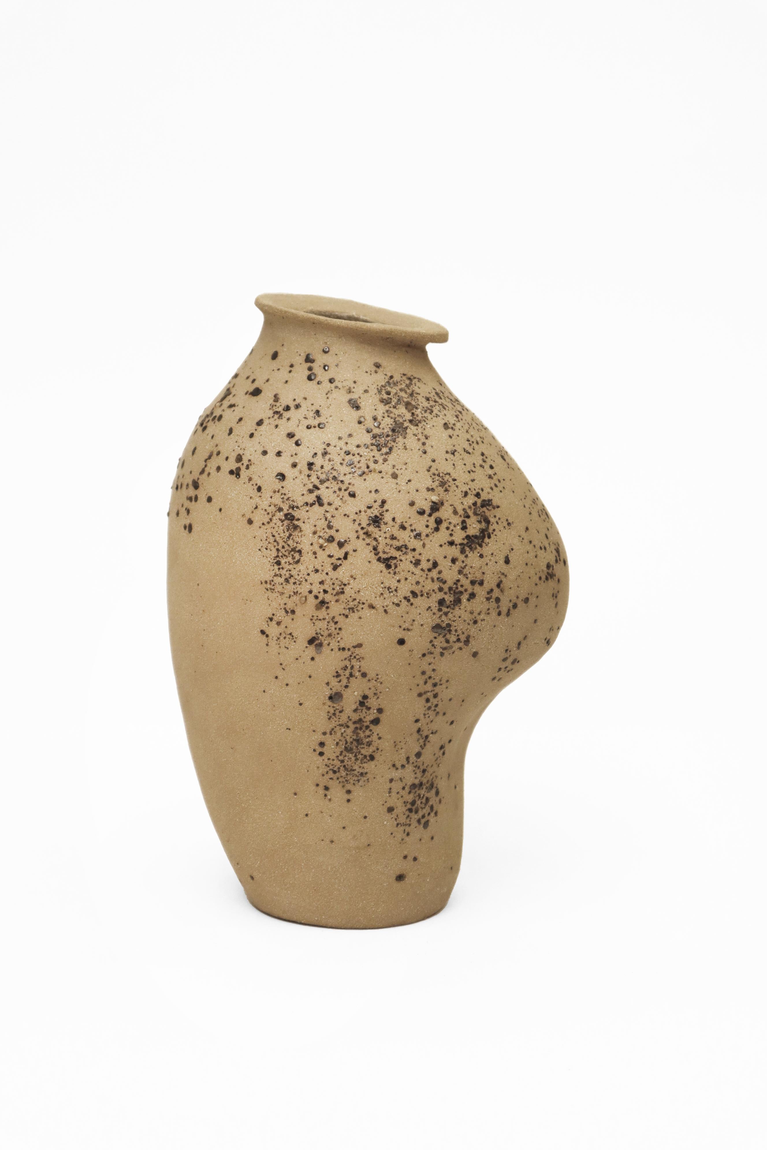 Stomata 3 vase by Anna Karountzou
Dimensions: W 13 x D 11 x H 22 cm
Materials: Beige stoneware clay, clear glaze inside, decorated outside with volcano rocks collected from Santorini, fired at 1240

Born and based in Athens, Greece, with a